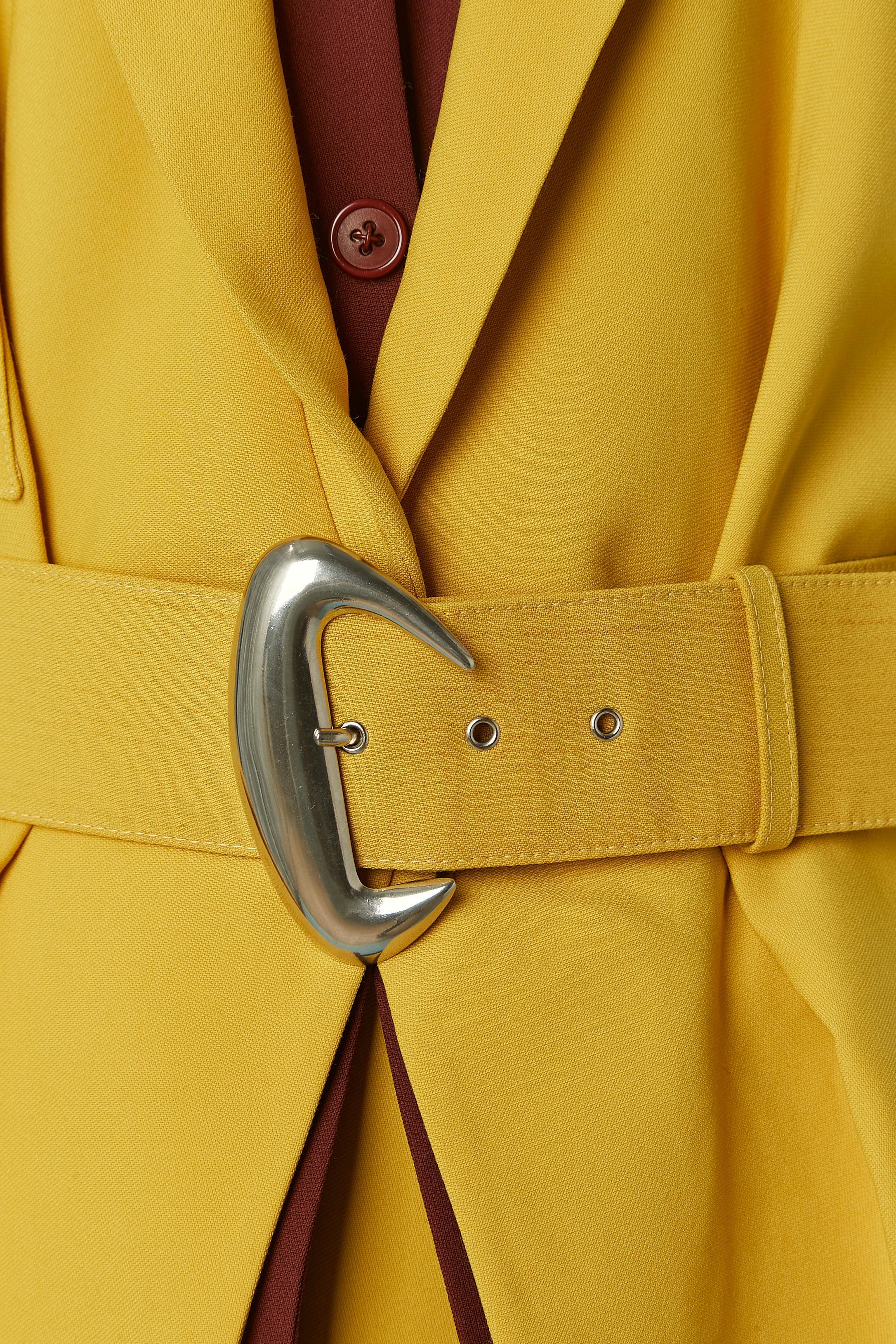 Yellow and brown skirt suit and double-jacket trompe l'oeil. Main fabric composition: 75% wool, 25% rayon. Acetate lining. Double snap closure on the middle front of the jacket ( 2 on the brown shirt and 1 on the yellow jacket) covered with button.