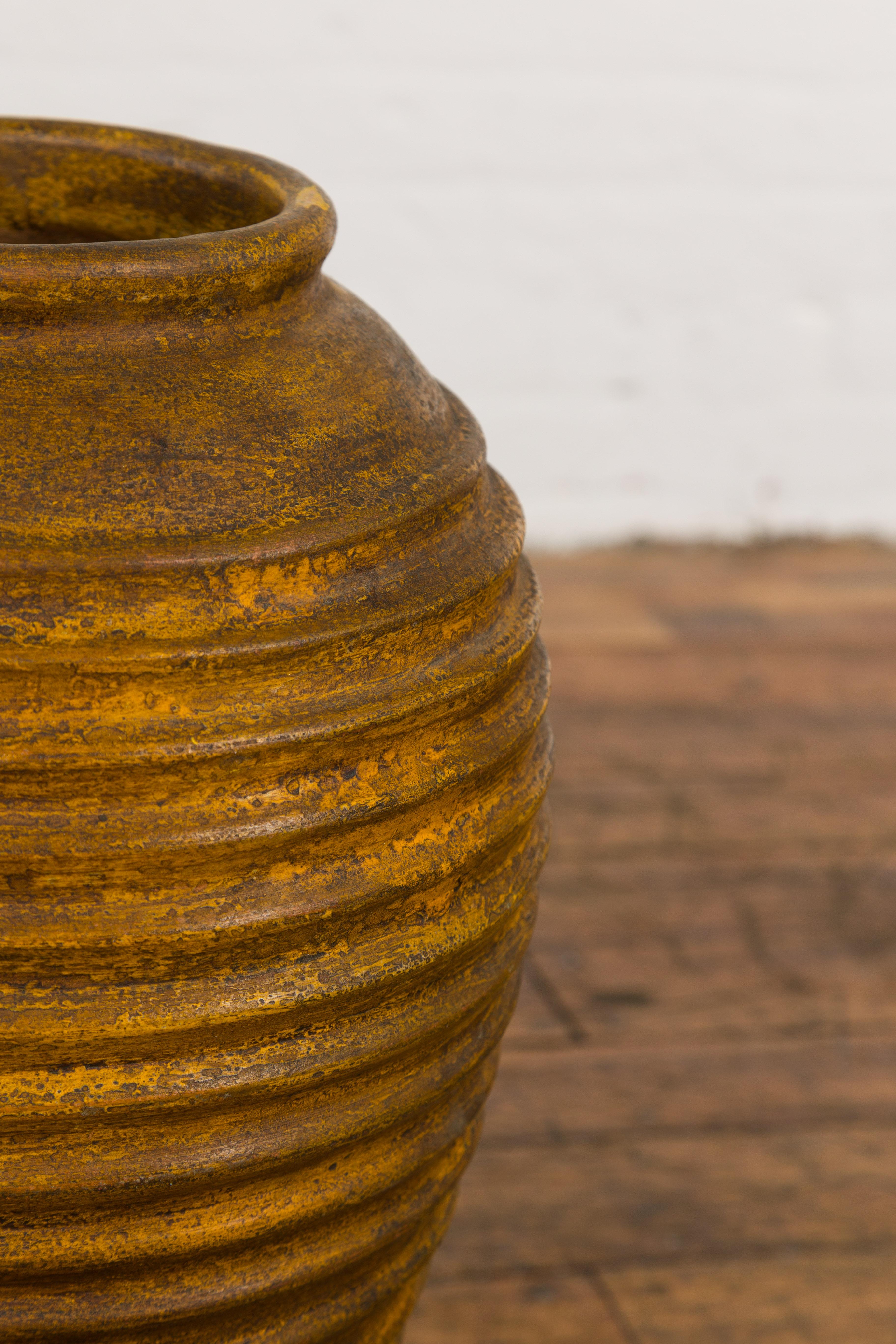 Yellow and Brown Storage Vase with Concentric Design and Rustic Character 4