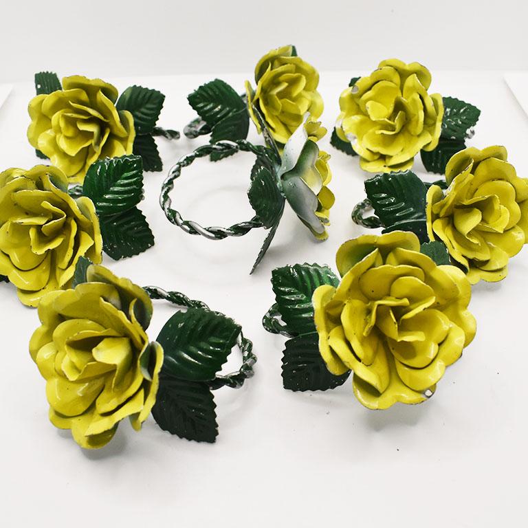 A set of eight metal tole yellow and green floral motif napkin rings. Each ring features a large yellow flower, atop a twisted green metal ring. Green flowers accent each flower around its side. 

Dimensions:
2.5