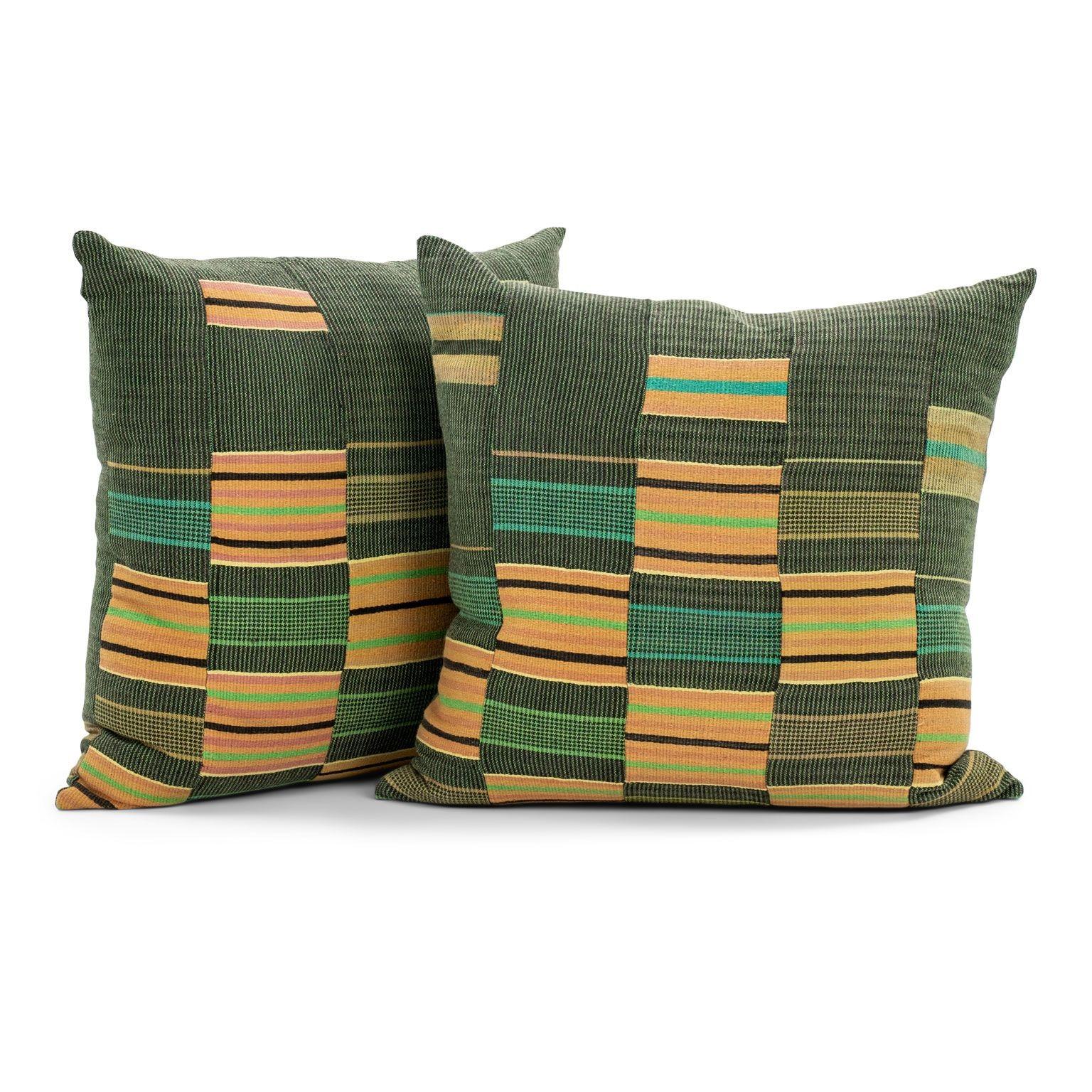 Yellow and Green Nwentoma cloth cushions: thick vintage cotton Kente fabric from Africa in hand-dyed green and yellow colors. Cushions include fasteners and feather inserts. Sold separately and priced $375 each.