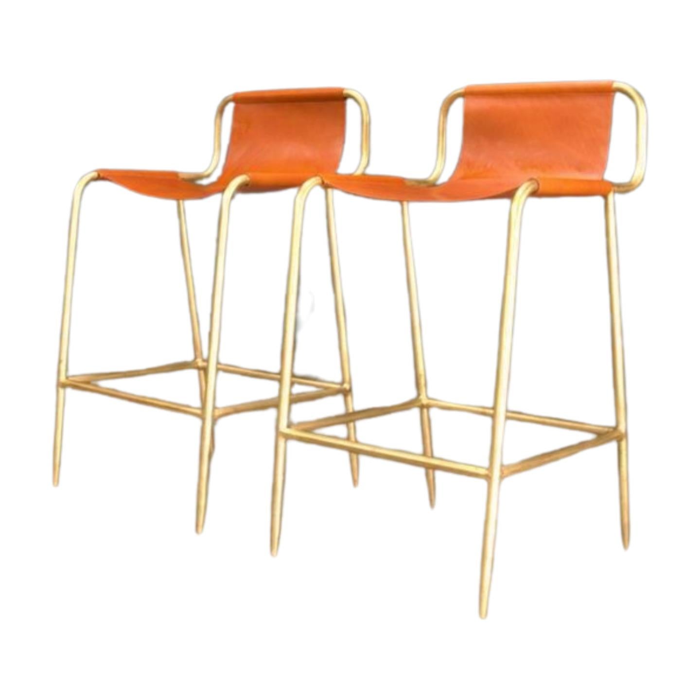 A wonderful set of four, Bill Amberg Leather Counter Stools avalible. These leather counter stools designer by Bill Amberg, crafted arround 2015, feature a sleek and modern design with solid brass accents and a sling leather chair detail. Perfect