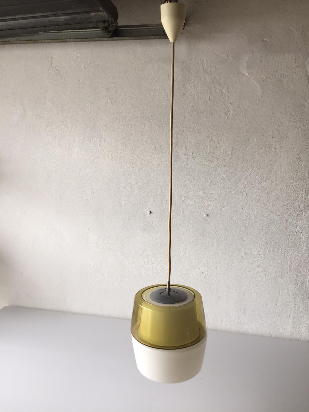 Yellow and milk glass pendant lamp by Peill & Putzler, 1960s, Germany

Unusual and rare design. 

Lampshade is in good condition and very clean. 

This lamp works with E27 light bulb. Max 100W
Wired and suitable to use with 220V and 110V for
