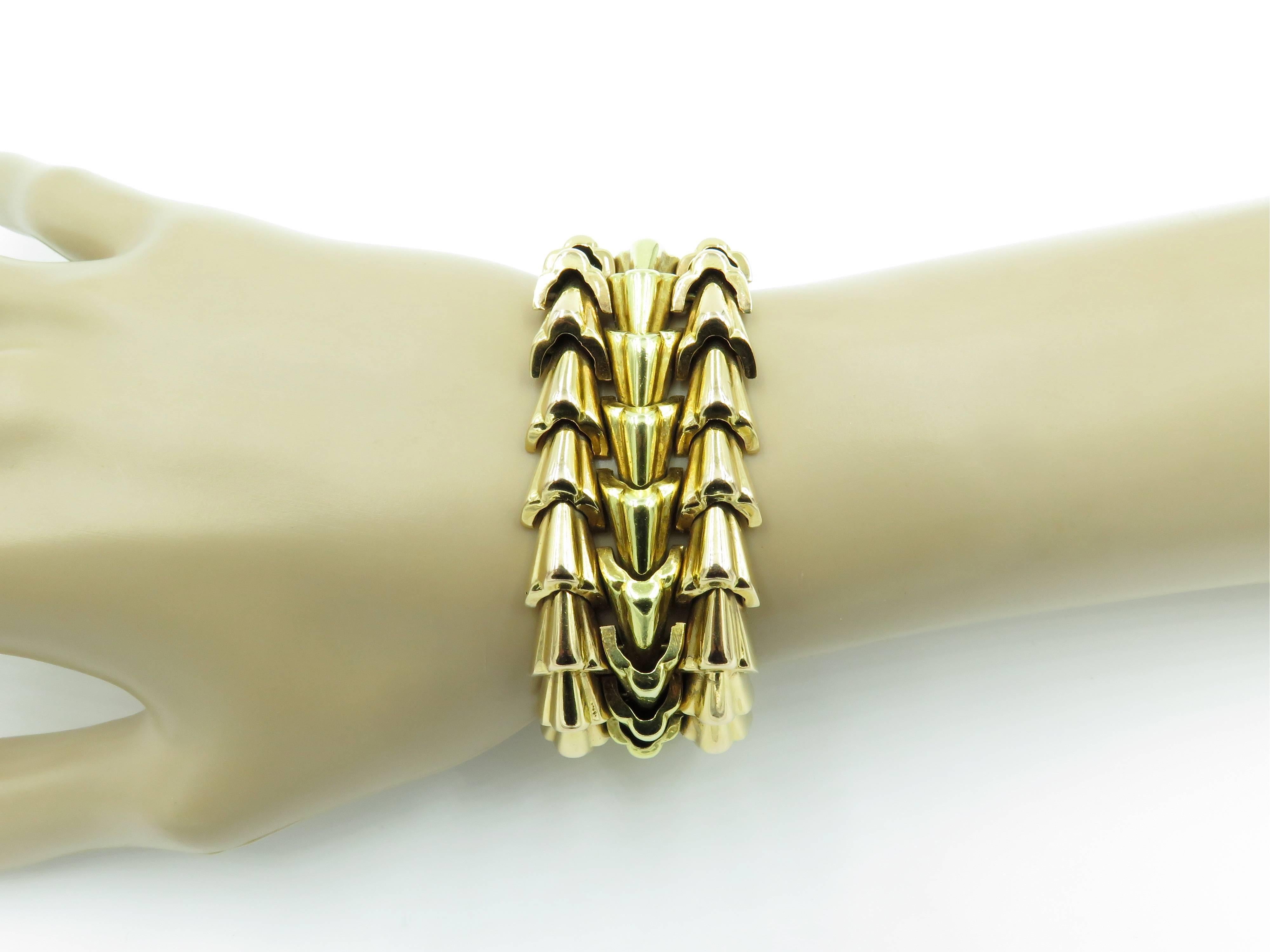 An 18 karat yellow and rose gold bracelet. Circa 1940. Designed as an articulated openwork band composed of fluted gold links. Length is approximately 7 inches. Gross weight is approximately 80.5 grams.