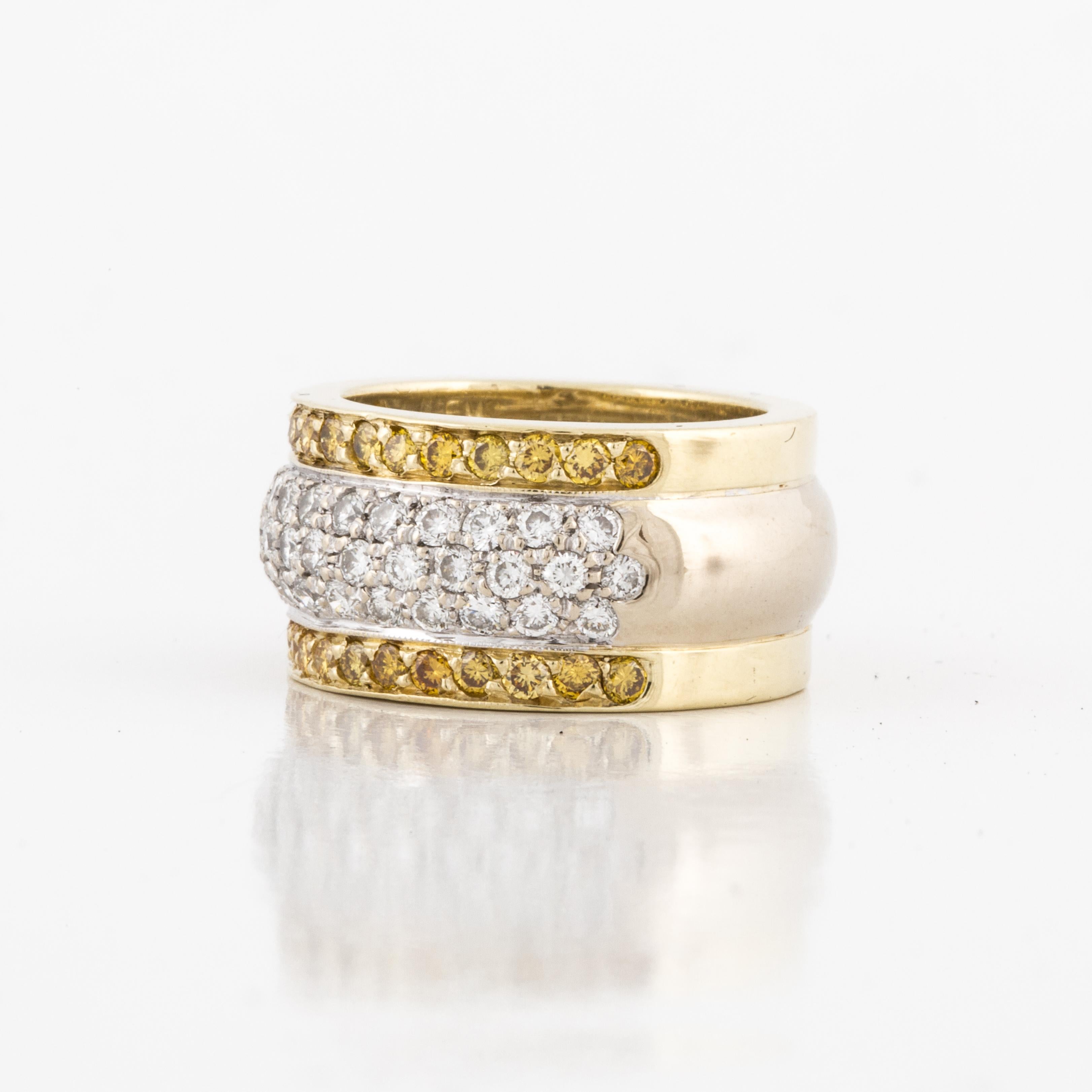 18K yellow and white gold cigar band set with pavé yellow and white diamonds.  There are 28 round yellow diamonds that total 0.85 carats;  Fancy Intense Yellow and VS1-SI1 clarity.  There are 37 round diamonds that total 1.30 carats; F-G color and