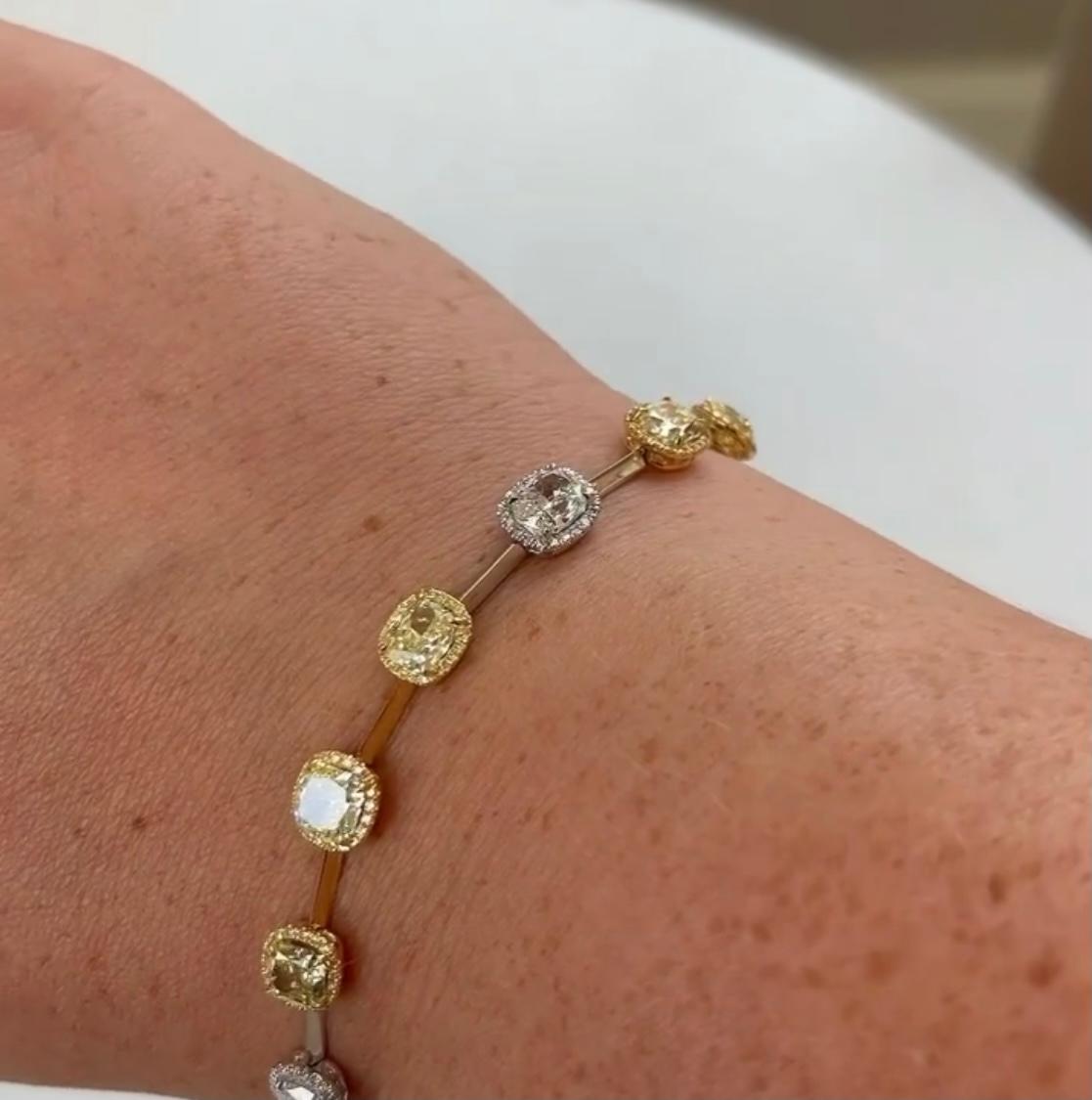 Abstract and Sophisticated Yellow and White Diamond Bracelet.

9 Yellow Diamonds weighing 6.30 Carats
3 White Diamonds weighing 2.10 Carats

Round Diamond of White and Yellow totaling 1.11 Carats