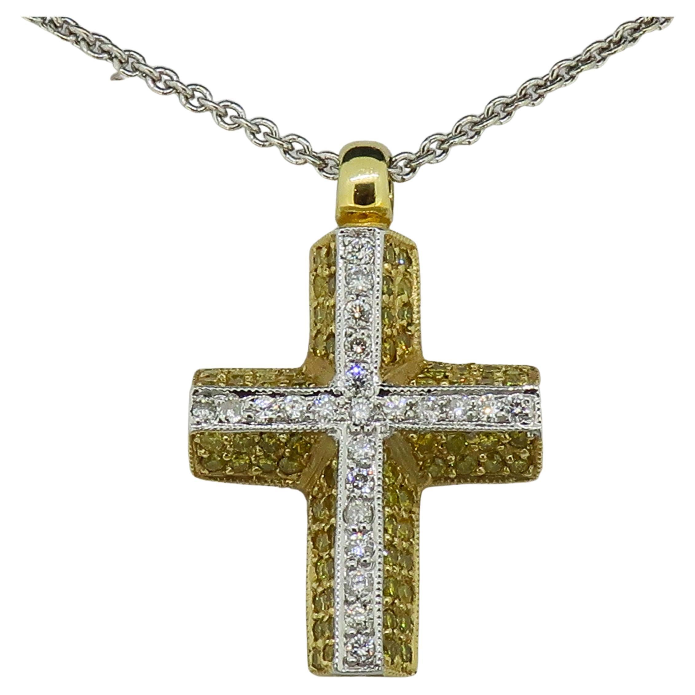 Yellow and White Diamond Cross Pendant 18 Karat Yellow and White Gold

Gorgeous diamond cross. Consisting of small yellow and white brilliant cut diamonds pave set all over the cross. One raised row of white brilliant cut diamonds in 18ct white gold