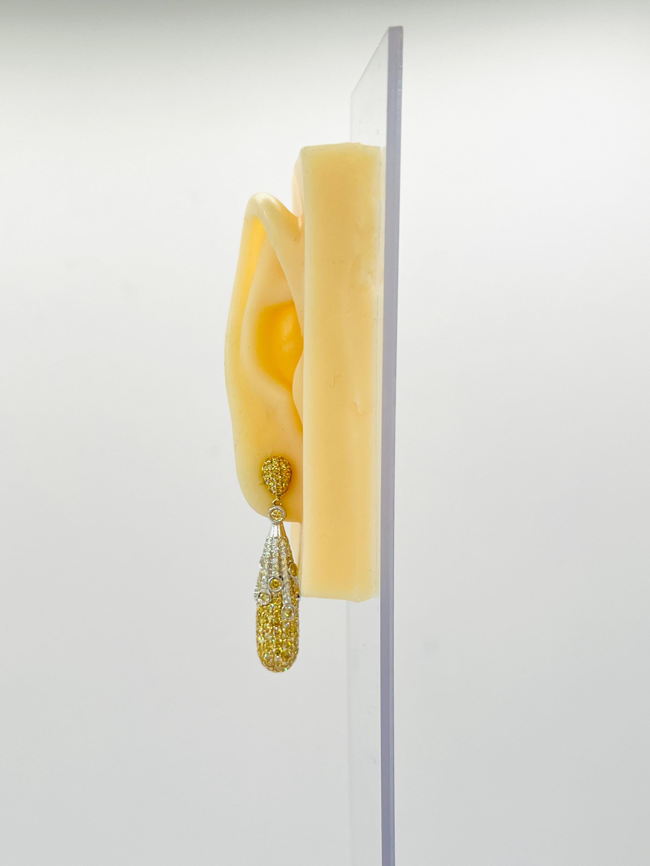 Beautiful day to night earrings with 3.49 ct. yellow diamond rounds and 1.88 ct. white diamond rounds.  Push back setting.  Handmade in 14k yellow and white gold.