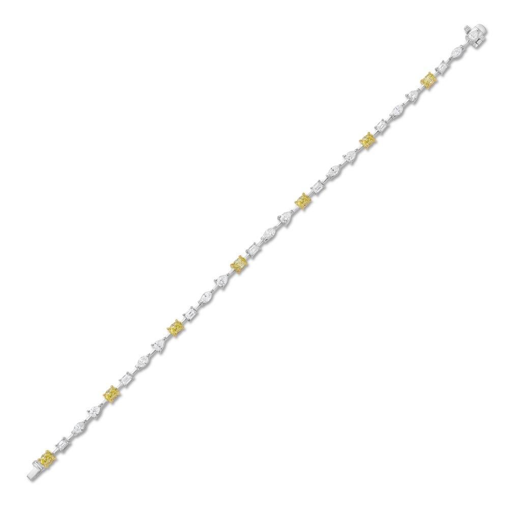 This charming mixed shape yellow and white diamond tennis bracelet brings playful elegance to a classic silhouette. With a total of 3.38 carats, it features 1.40 carats of yellow oval diamonds paired with 1.98 carats of white diamonds in a variety