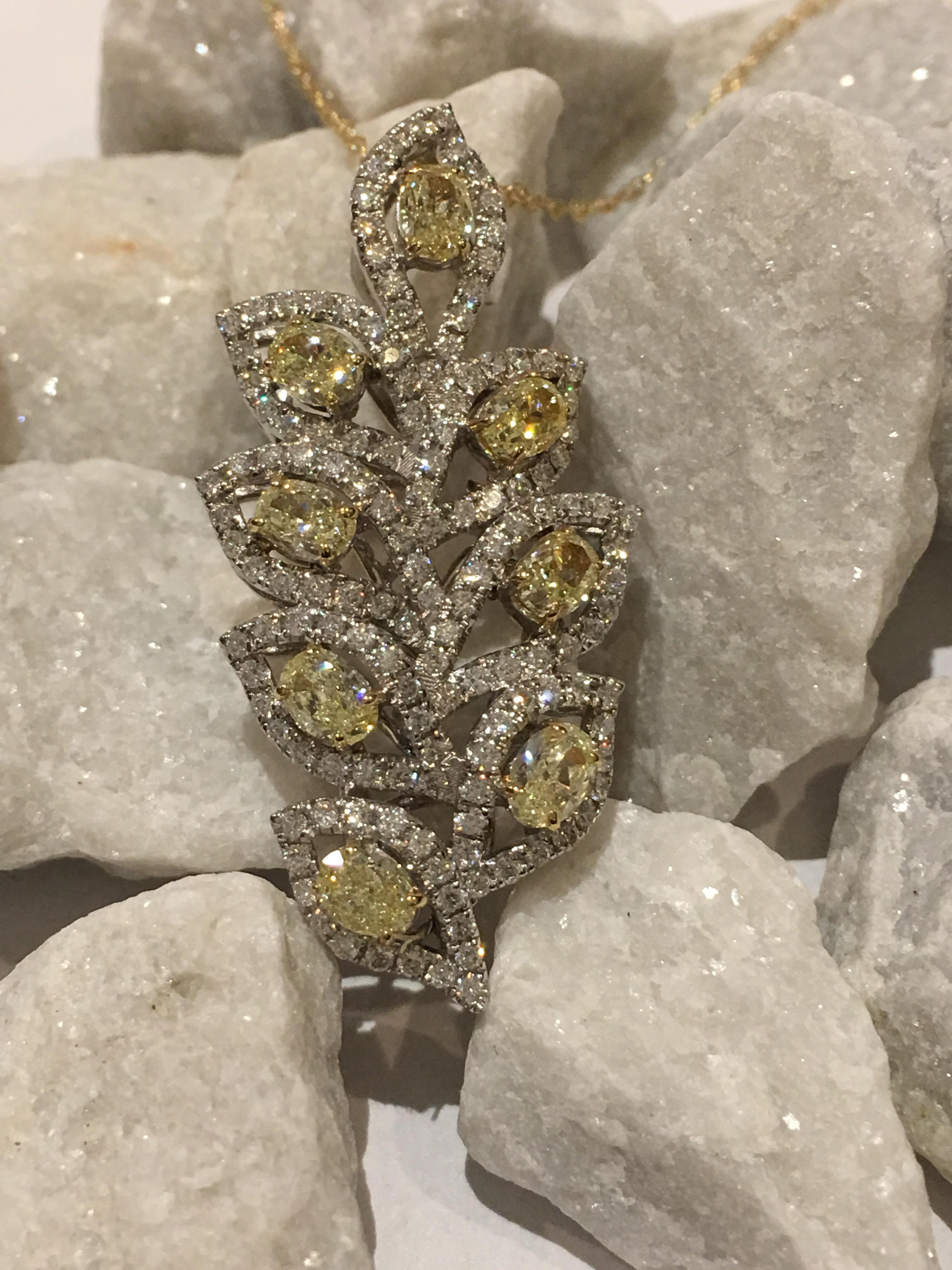 Oval Yellow Diamond and White Round Diamond Leaf Pendant set in 18K Two tone gold , with 18 inch  Gold chain.
Oval Yellow Diamond is 1. 47 Carat and other round Diamond is 0.71 Carat. The pendant is one of a kind hand crafted. 