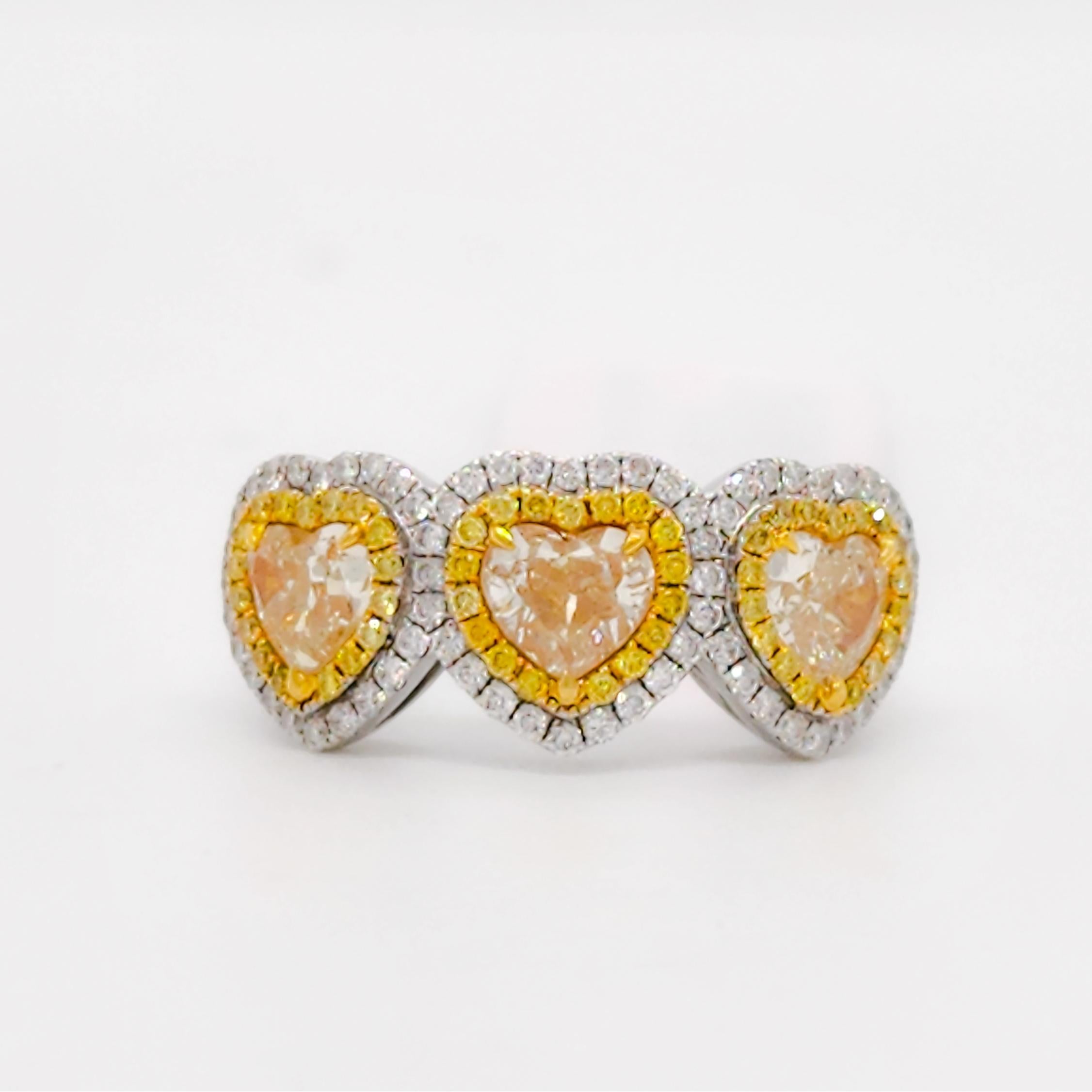 Gorgeous three heart ring with 1.68 ct. bright yellow diamond heart shapes and 0.57 ct. yellow and white diamond rounds.  Handmade in 18k white and yellow gold.  Ring size 6.25.