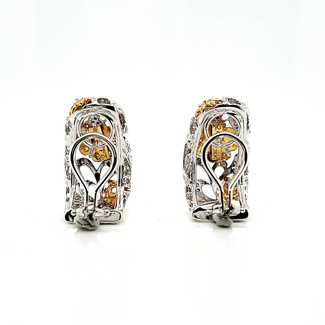Blossoming with elegance, these earrings feature a captivating flower design that's sure to turn heads. 

White diamonds totaling 1.41 carats form the center stone and delicate leaves, while vibrant yellow diamonds totaling 0.40 carats adorn the