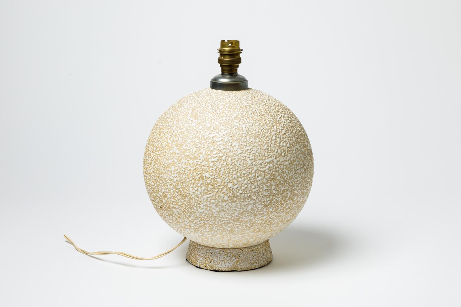 Yellow and white glazed ceramic table lamp. 
Circa 1920-1930.
H : 10.2 x 7.9 inches (ceramic only).
Sold with a European electrical system.

