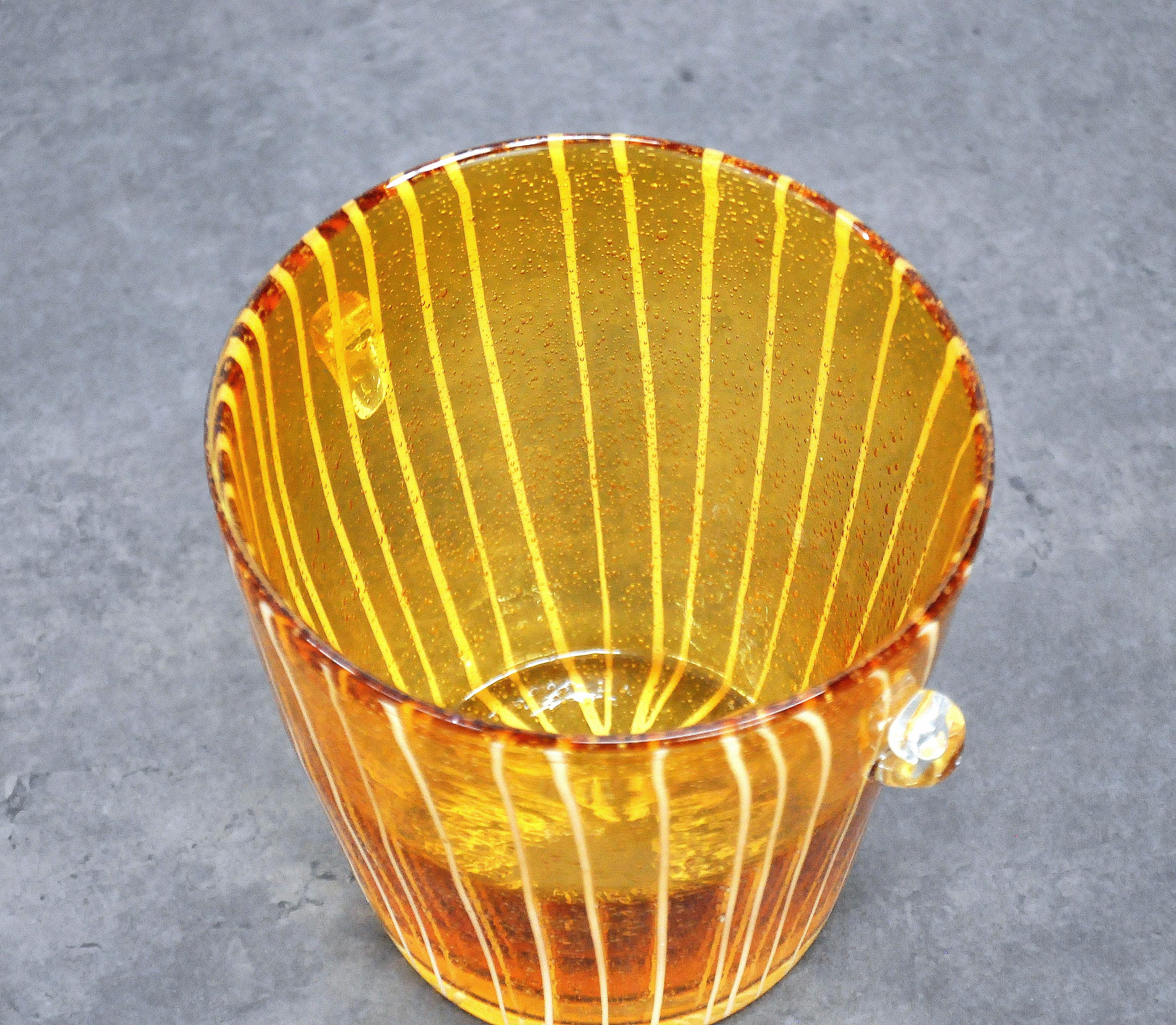 Vintage Venetian hand blown amber glass vessel, with white stripes, controlled bubble design, and clear handles. A nice example of Italian art glass with wonderful lines and a very decorative color.
 
