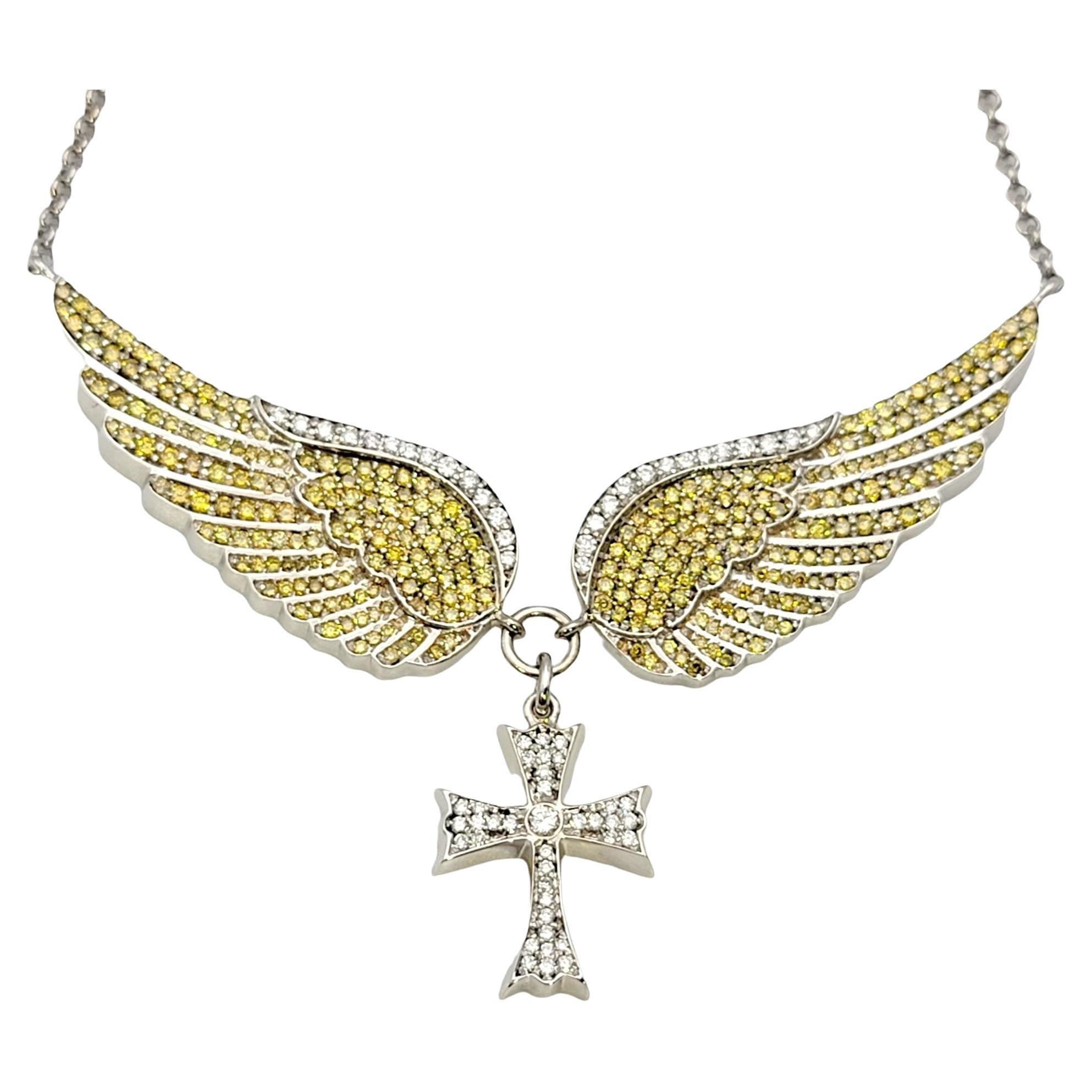 Collier croix et ailes en or blanc 14 carats avec diamants pavés jaunes et blancs