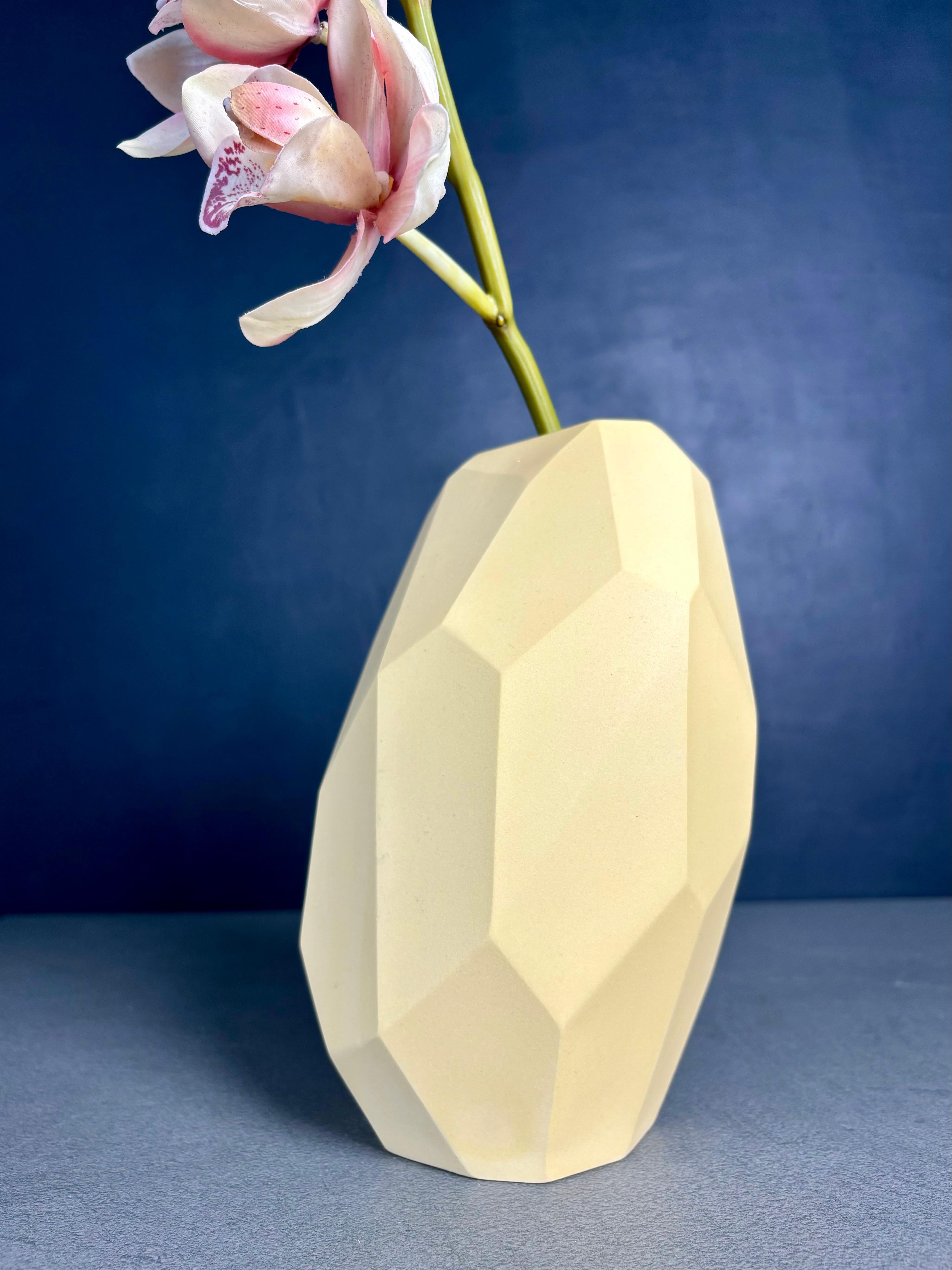 Limited edition contemporary light yellow ceramic sculptural vase by Danish ceramic artist Anne Jørgensen for AJ Ceramics. The sculptural slanted design consists of multiple sharp angles and different size surfaces from top to base, all sanded by