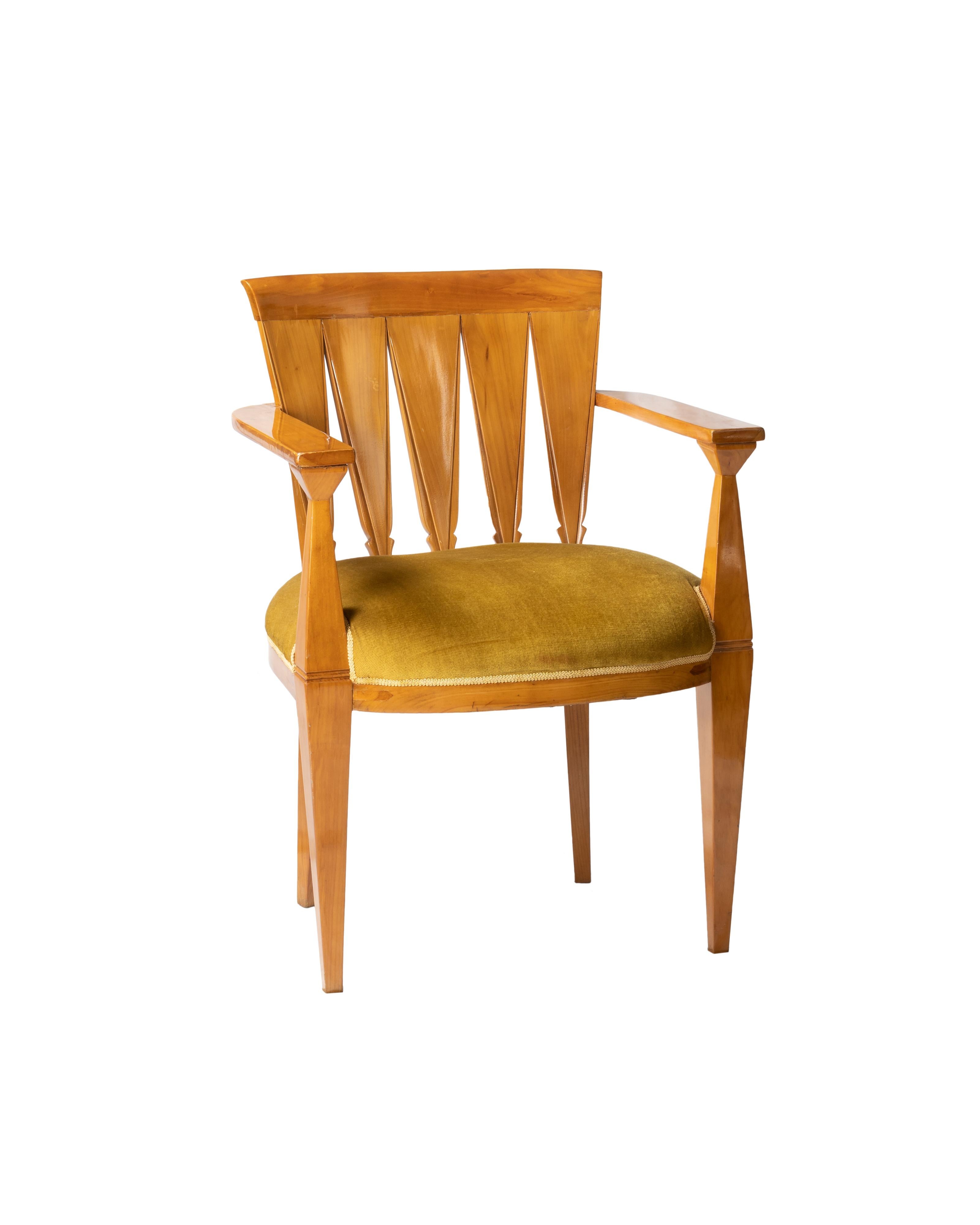 Art Deco Sessel mit hölzerner Rückenlehne, Armlehnen und breiter Sitzfläche, senffarben gepolstert.