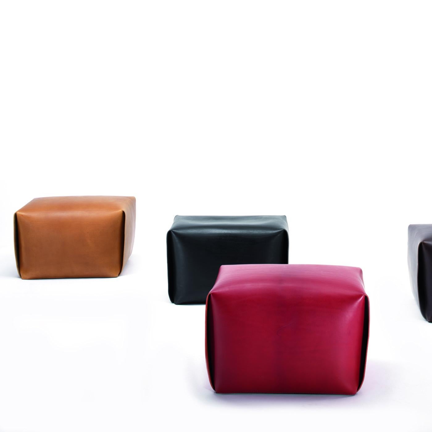 Borrowing inspiration from origami art, this splendid ottoman combines functional and aesthetic qualities, balancing the angularity of its silhouette with the soft quality of the leather. The rectangular wooden frame, containing high-density