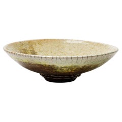 Yellow/beige glazed ceramic cup with metallic highlights by Gisèle Buthod Garçon