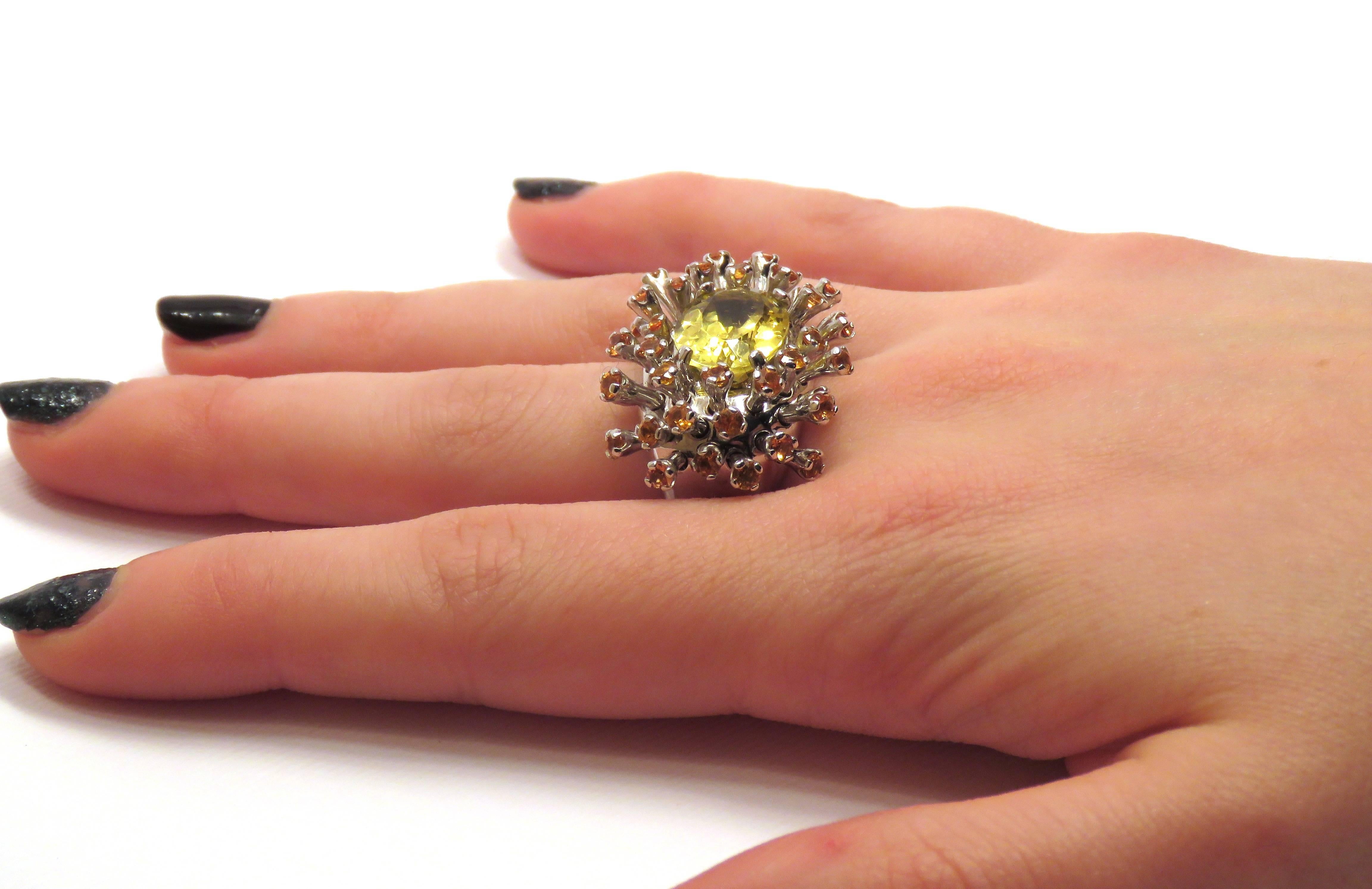 Stunning Sea Anemone cocktail ring inspired by symbiosis, the glittering yellow beryl in the centre is sourrounded by bright orange sapphires symbolizing the perfect combination. Handcrafted in 18 karat white gold. The natural yellow beryl weighs