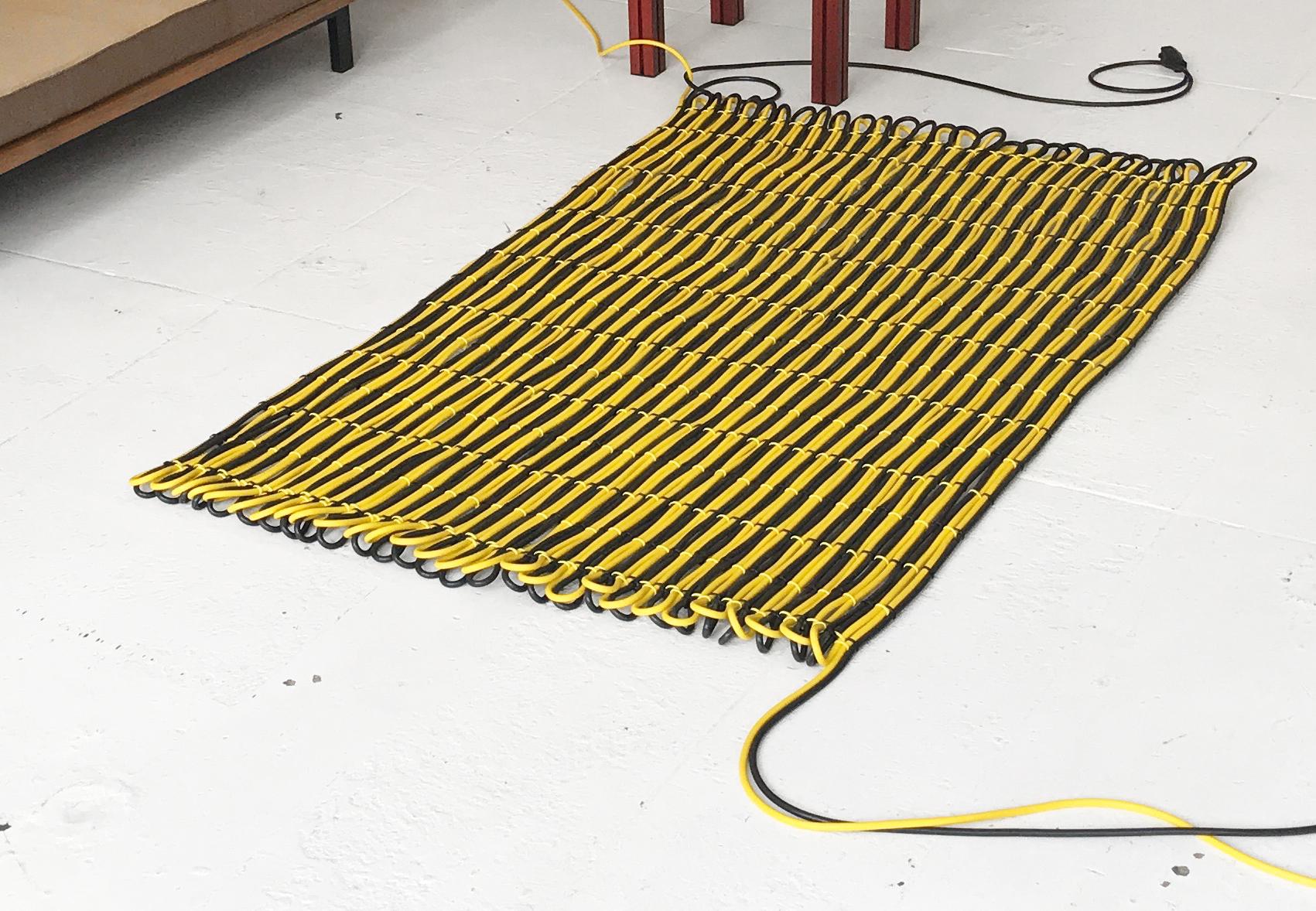 200 Meter Cable Wall rug / tapestry
Dimensions: W 105 x L 160 cm (˜ 1.7 m2 surface)
Materials: PVC electricity cable, cable clips, country specific plug and socket.
Available cable colours: black, yellow, orange, blue.

Cable rugs were originally