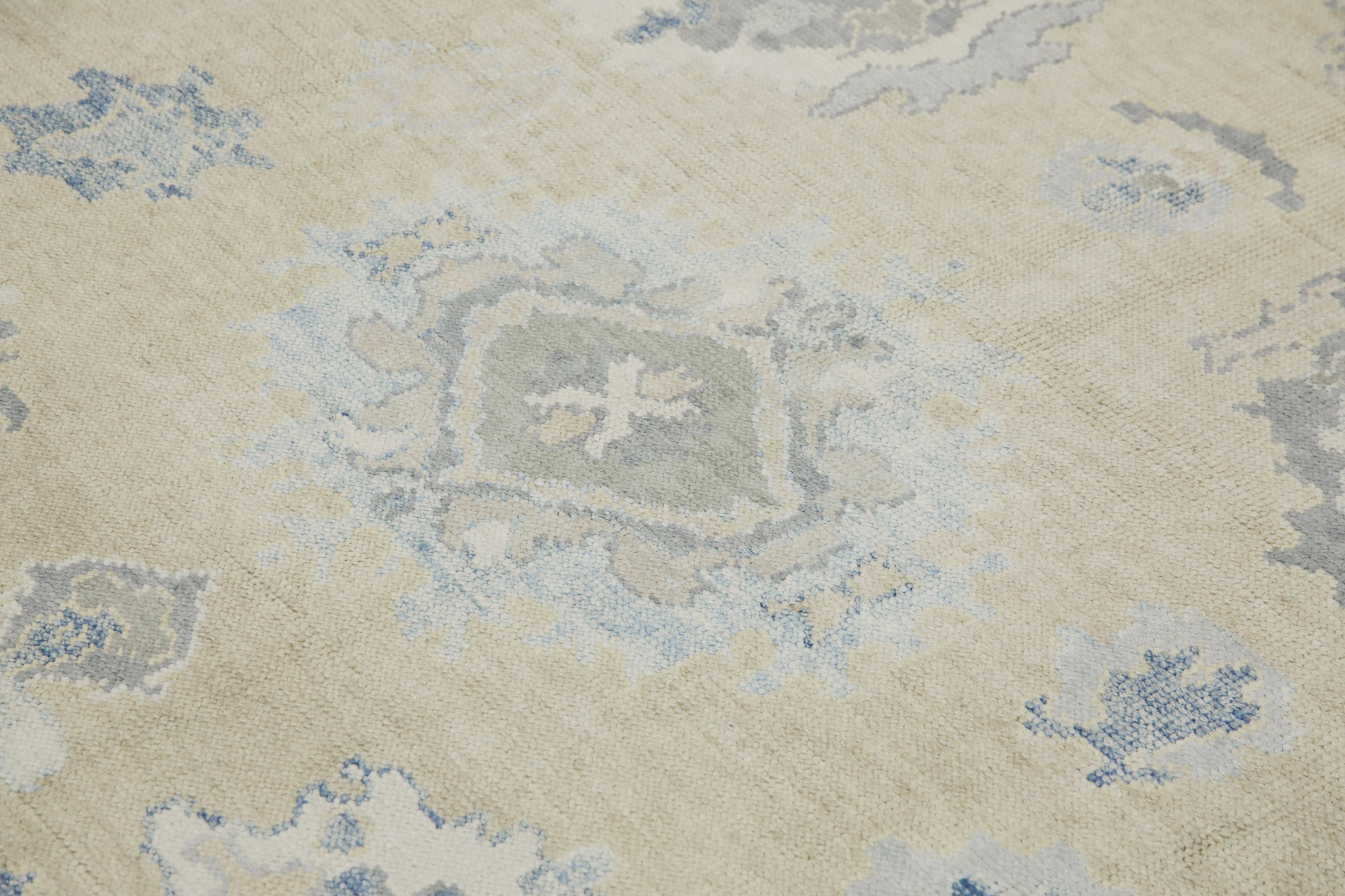 This modern Turkish Oushak rug is a stunning piece of art that has been handwoven using traditional techniques by skilled artisans. The rug features intricate patterns and a soft color palette that is achieved through the use of natural vegetable
