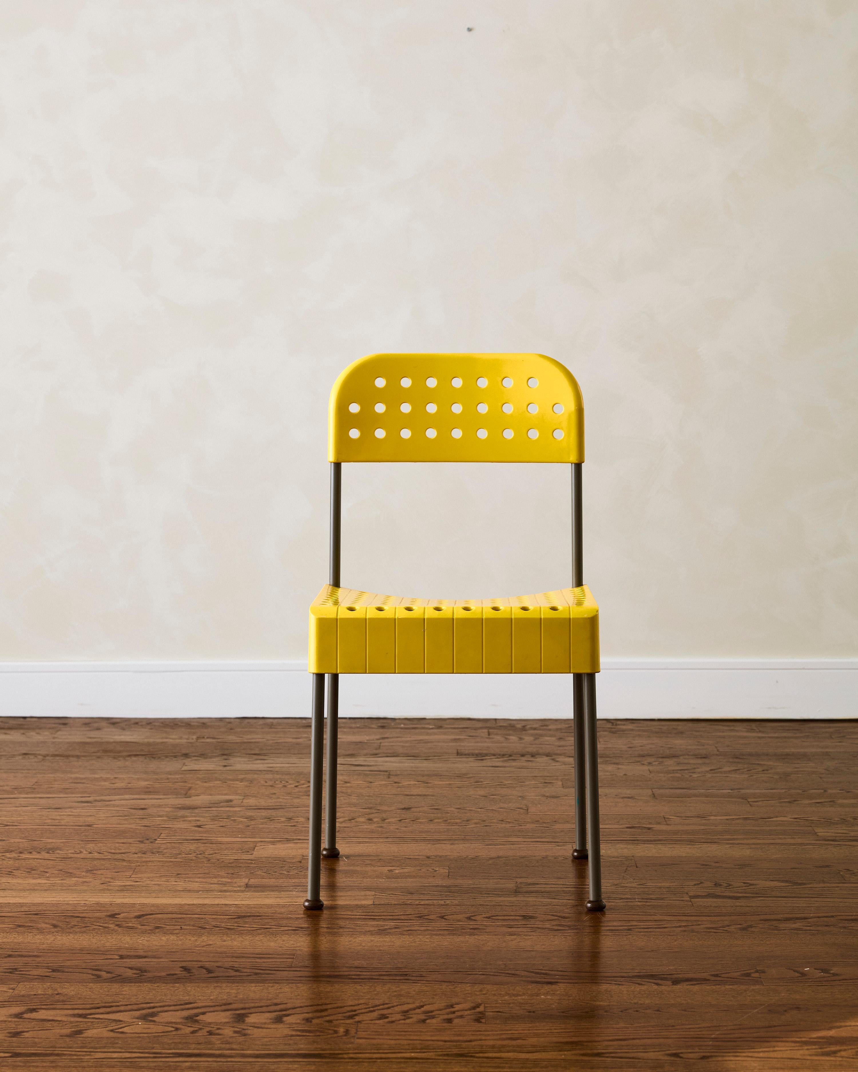 The Yellow Box Chair by Enzo Mari was produced by Anonima Castelli in Bologna, featuring a seat and backrest in yellow injection-molded propylene (plastic) and a removable structure in gray-painted tubular metal. 
