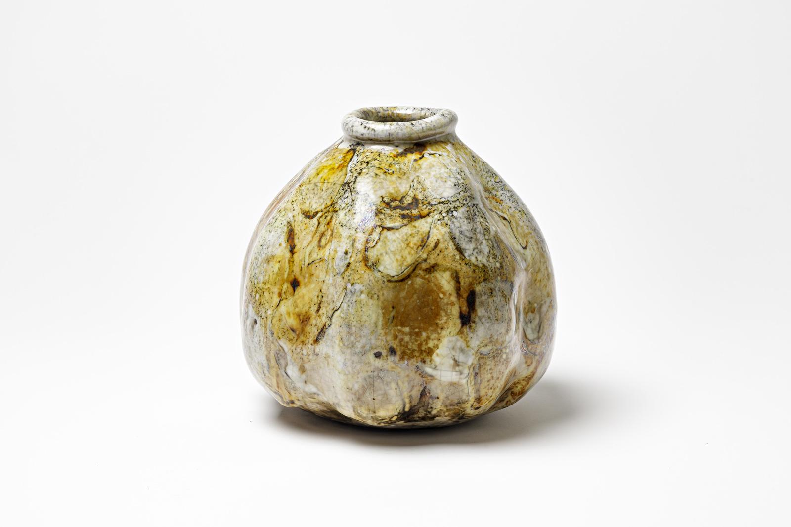 Yellow/brown and white glazed ceramic vase by Gisèle Buthod Garçon. 
Raku fired. Artist monogram under the base. Circa 1980-1990.
H : 8.3’ x 7.1’ inches.
