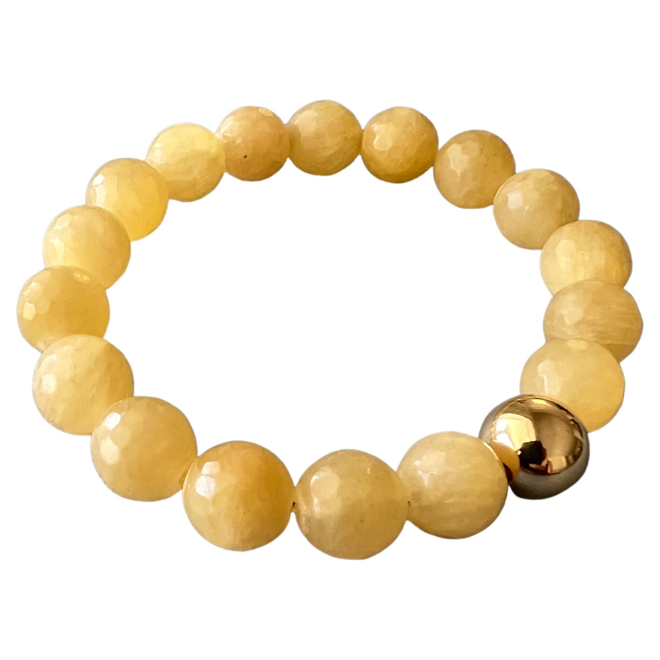 Yellow Calcite Faceted Round Bead Stackable Elastic Bracelet with Gold Filled Bead 

Made in Los Angeles

Designer: J Dauphin

Note: Every bead is in same size.

The Yellow Calcite Round Bead Bracelet with Gold Filled Bead interweaves radiant