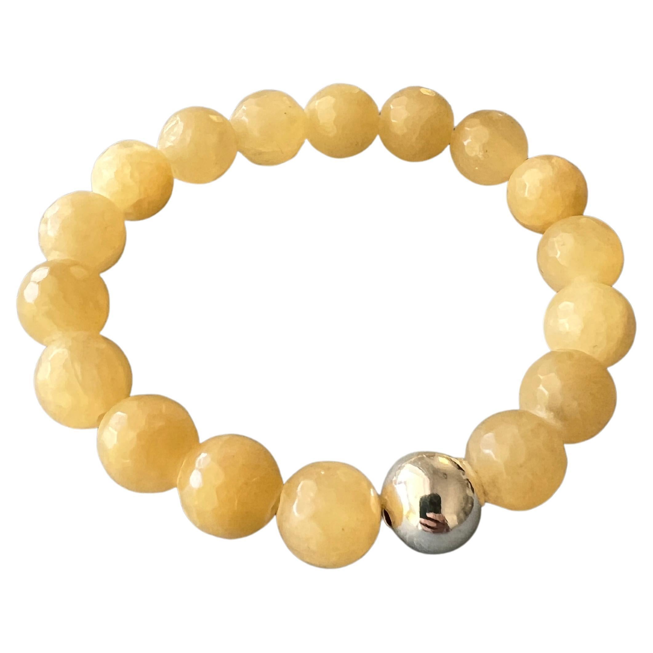 Yellow Calcite Faceted Round Bead Stackable Elastic Bracelet with Silver Bead 

Made in Los Angeles

Designer: J Dauphin

Note: Every bead is in same size.

The Yellow Calcite Round Bead Bracelet offers a subtle aesthetic appeal paired with unique