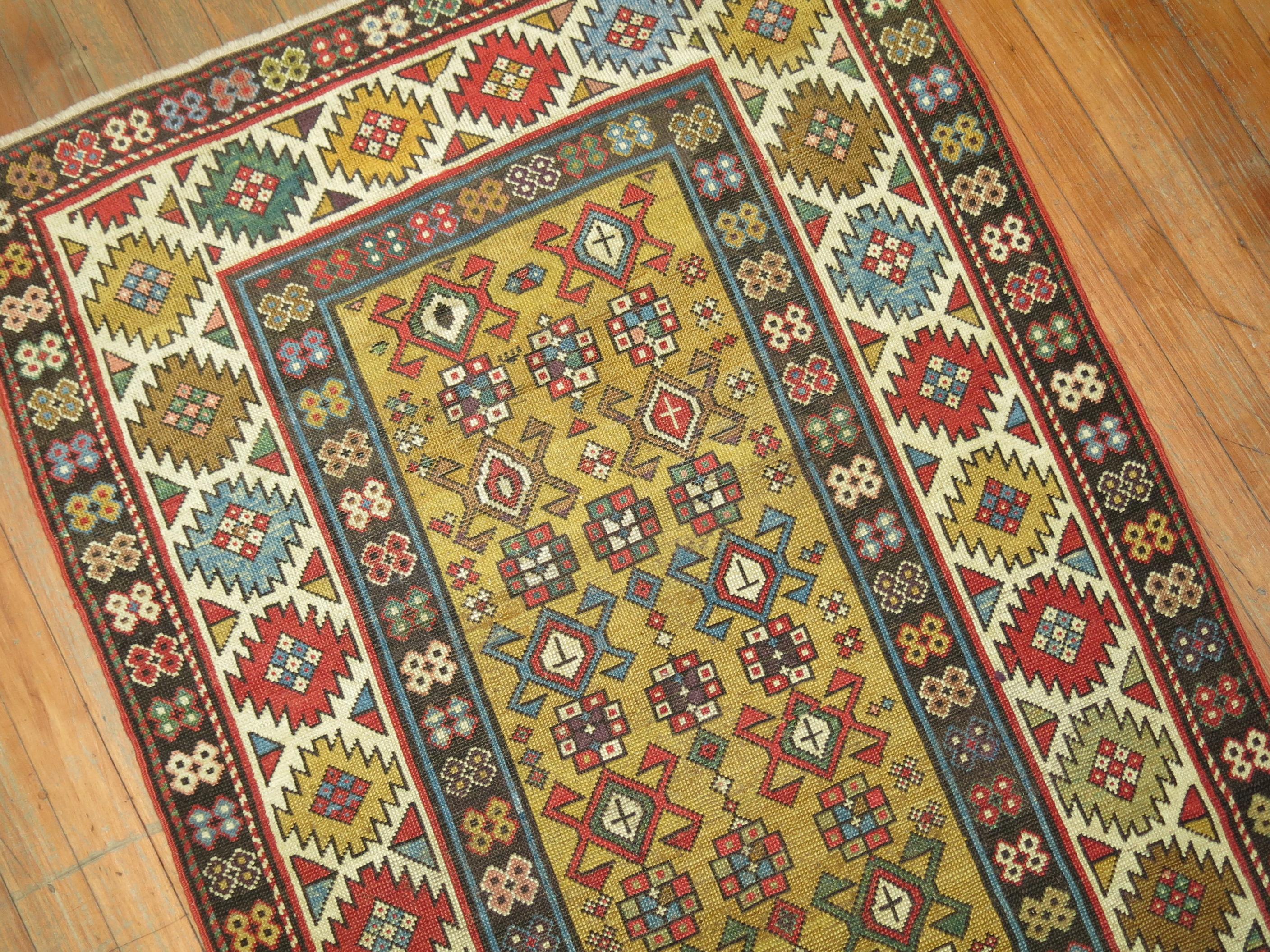 An early 20th century collectible - highly decorative Caliber Caucasian rug in rare yellow.

 