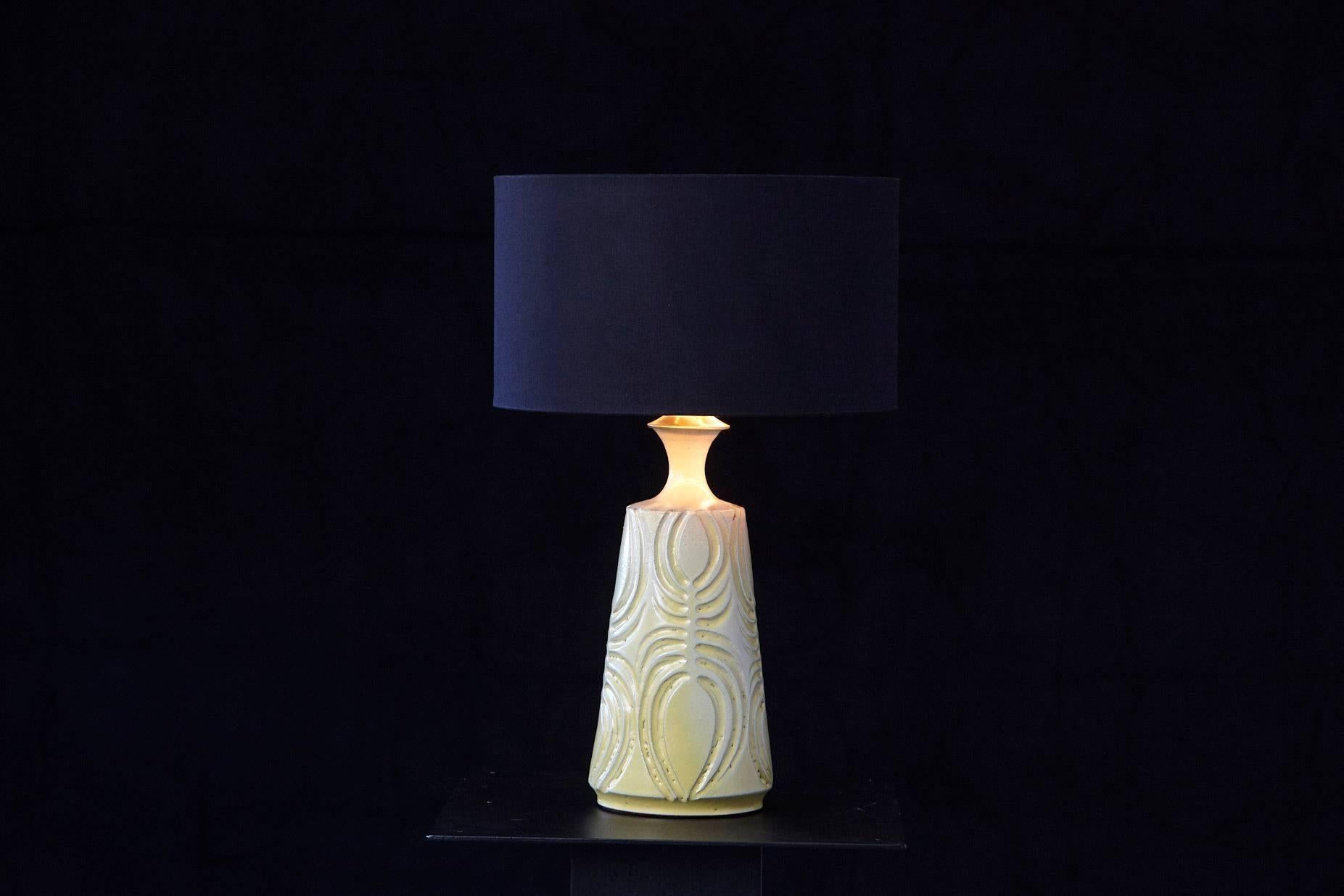 Gorgeous hand thrown ceramic lamp with a yellow glaze in from of a vase with tapering neck and flared rim. Deeply incised decorative lines. Hand-incised mark on the inside of the lamp, Robert Maxwell '71.
The lamp came with a pre-drilled hole for