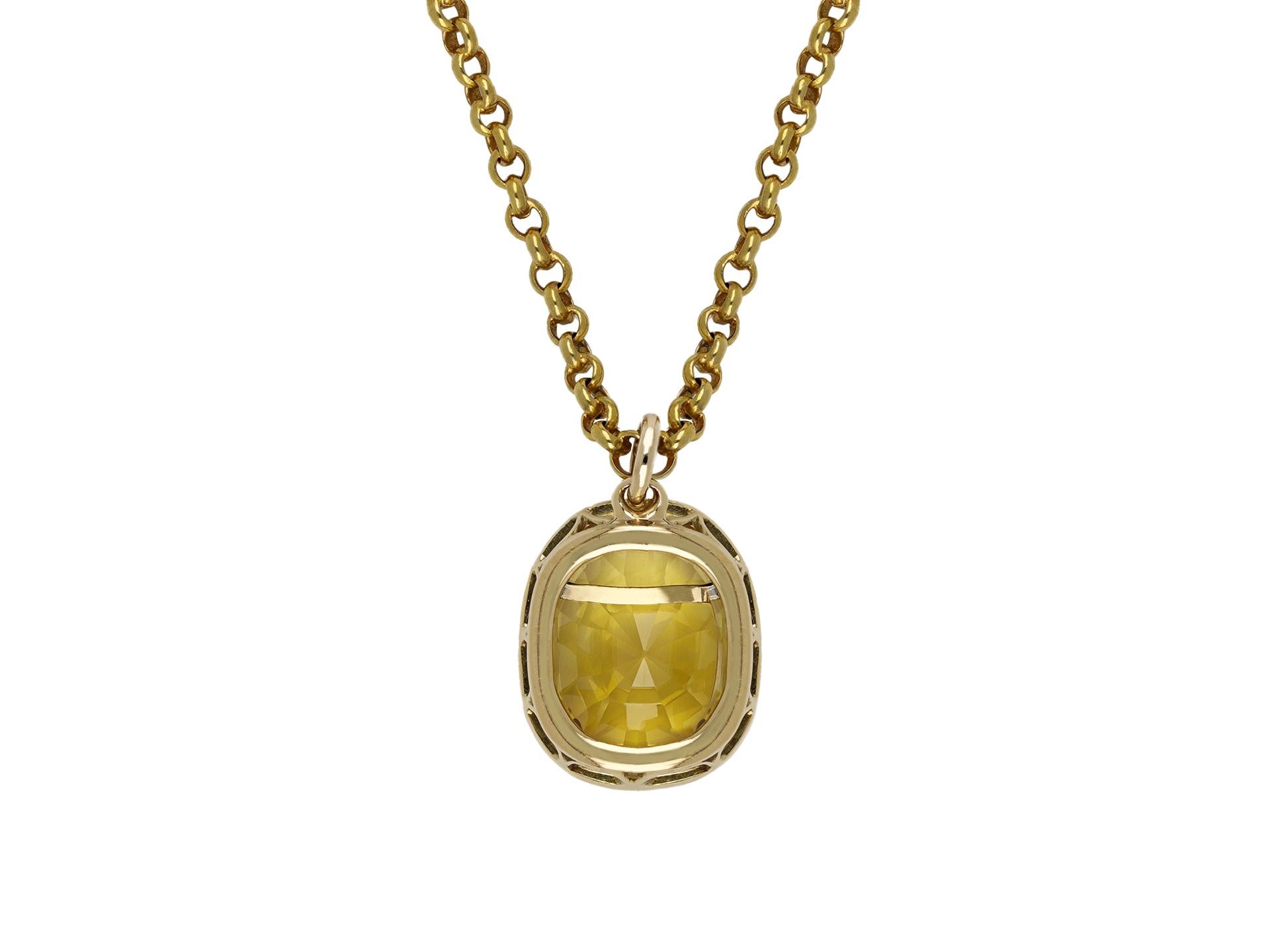 Yellow Ceylon Sapphire pendant. Set with a cushion shape old cut natural unenhanced yellow Ceylon sapphire in an open back claw setting with an approximate weight of 12.71 carats in open back cut-down setting, to an impressive pendant featuring an