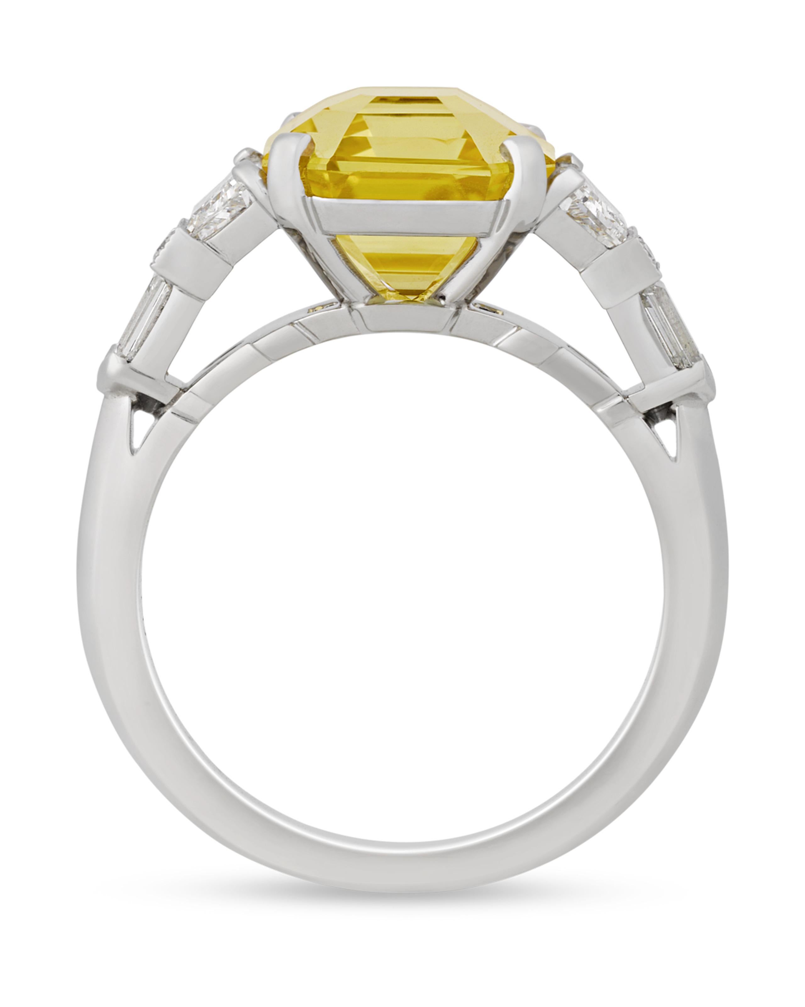 This classic ring features a fancy yellow Ceylon sapphire, one of the rarest of all fancy-colored sapphires. Weighing an impressive 5.09 carats, the octagonal step-cut jewel displays a superb yellow hue and is certified by the Gemological Institute