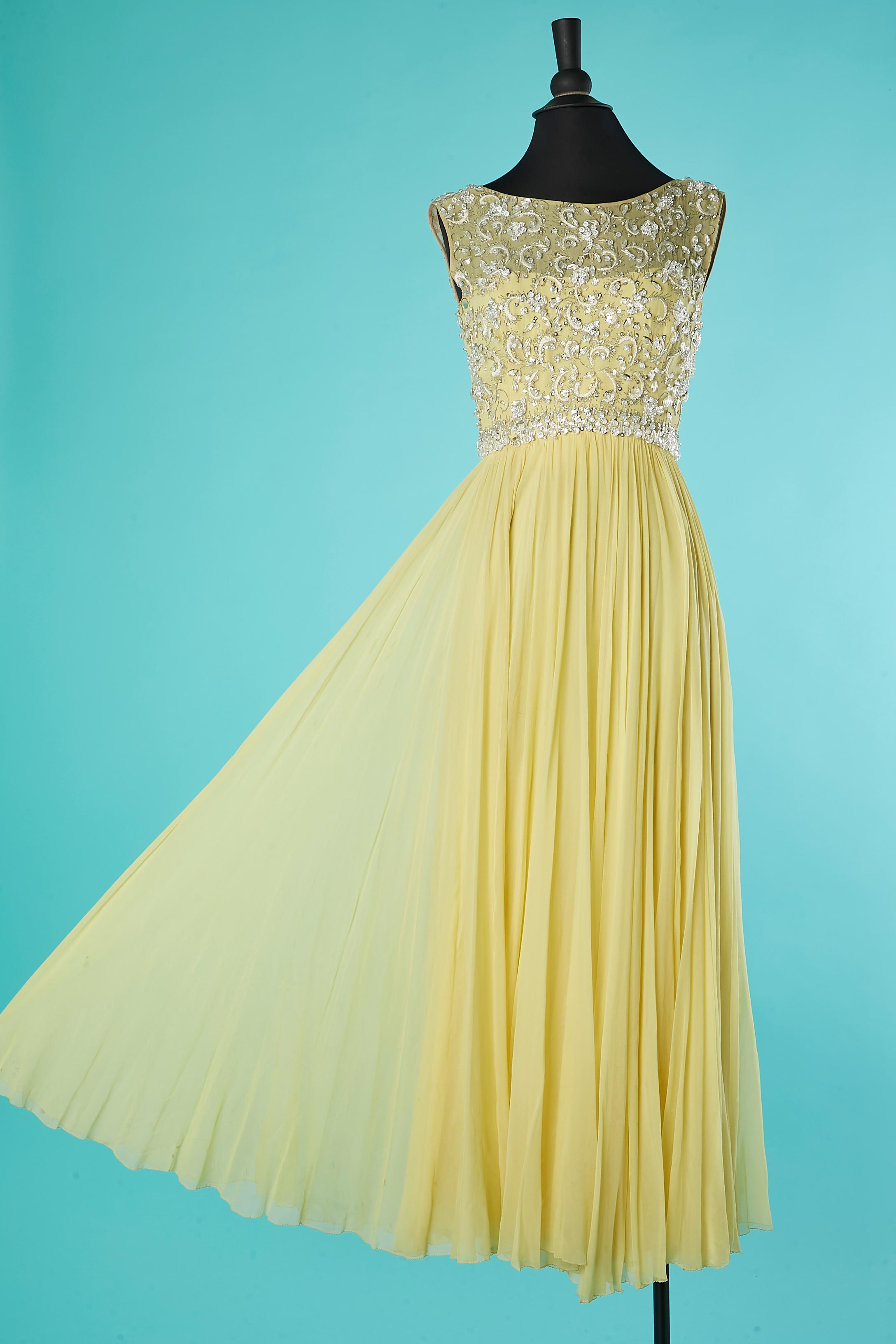 Yellow chiffon and beads cocktail dress . Zip middle back and hook& eye . Bust and  skirt are made of 2 lays attached together, one in rayon, one in chiffon. Boned waist band with hook&eye in the middle back.
SIZE S 