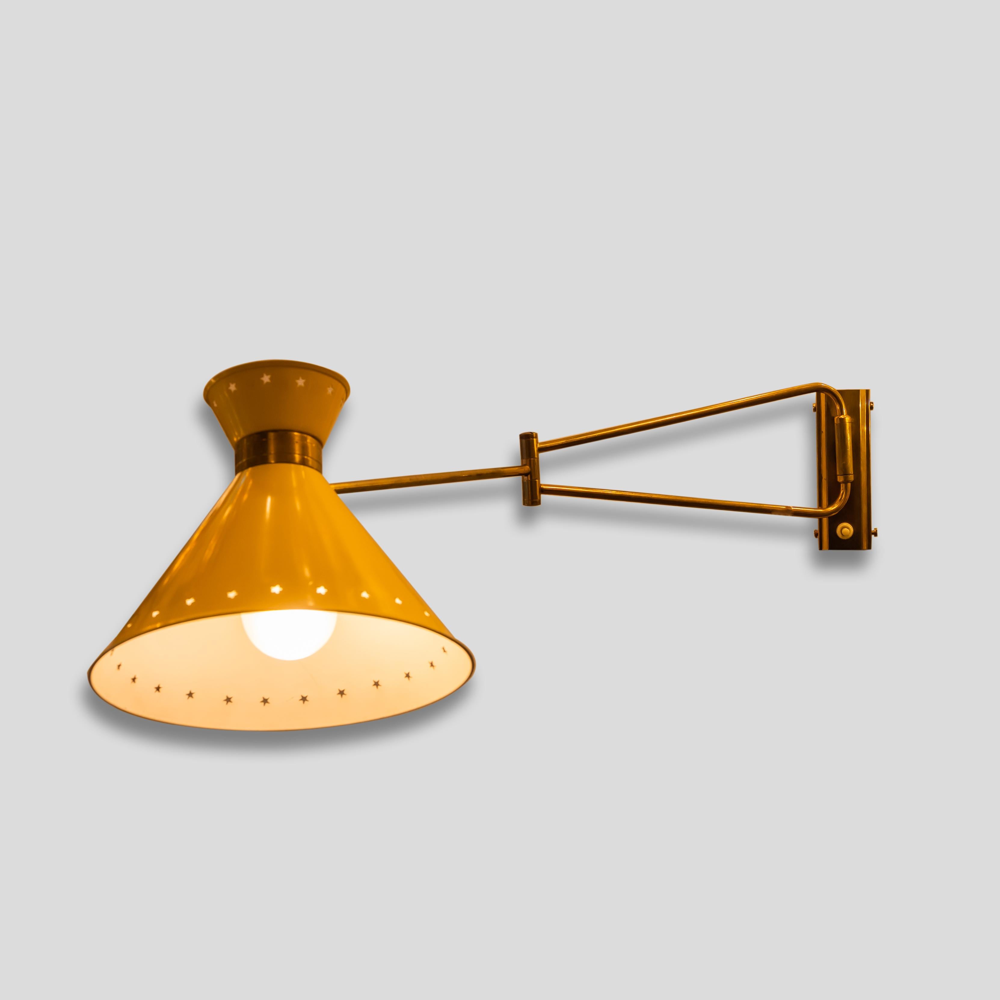 A sconce yellow enamelled color shade on brass structure, articulating shade and moving arm. 1950s design by Rene Mathieu for Lunel