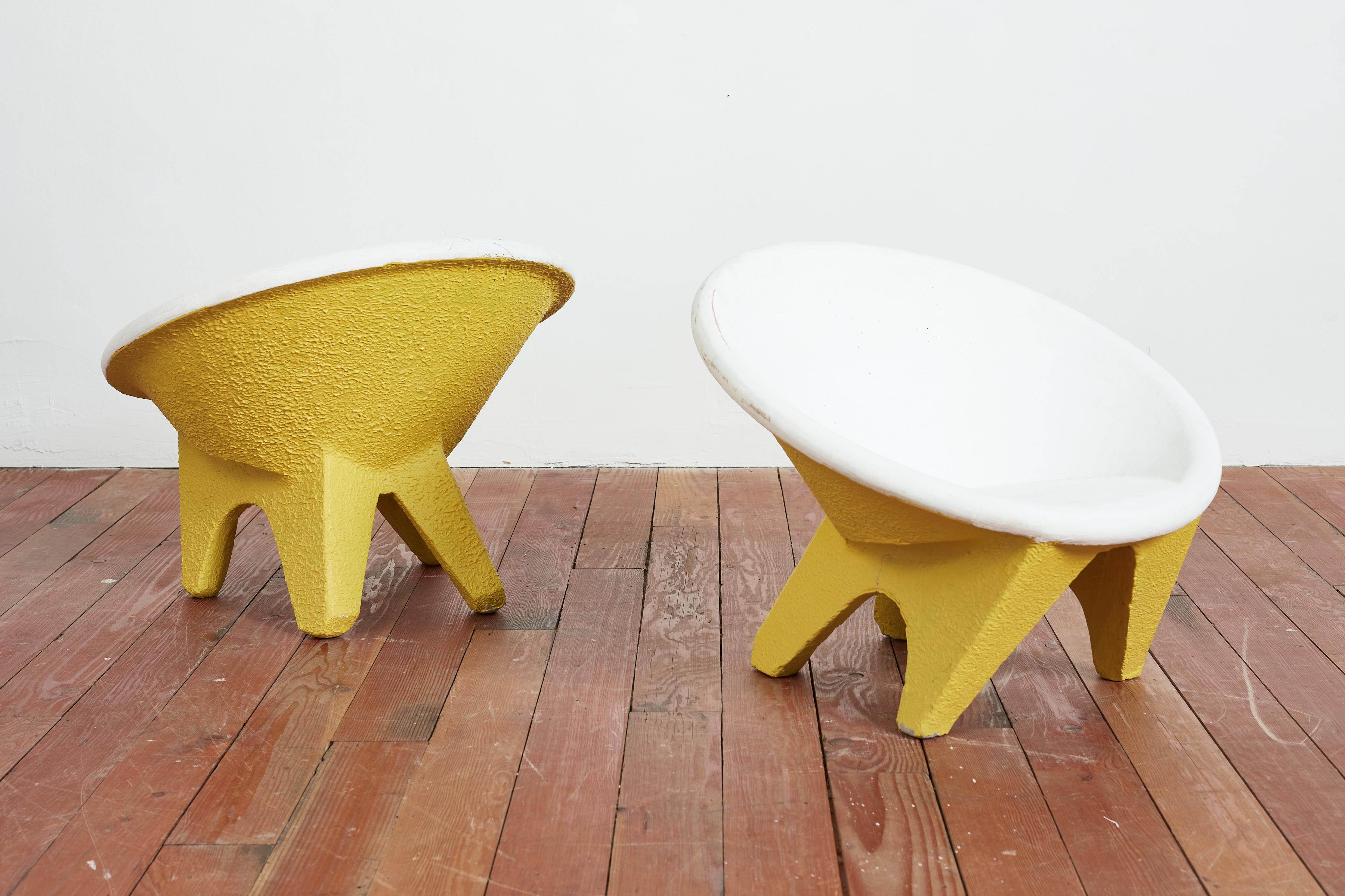 Solid concrete sculptural chairs with angular legs and round saucer seats
 - originally from Italy, 1960s.
Yellow exterior with white inside 

Chairs are sold as a set 

