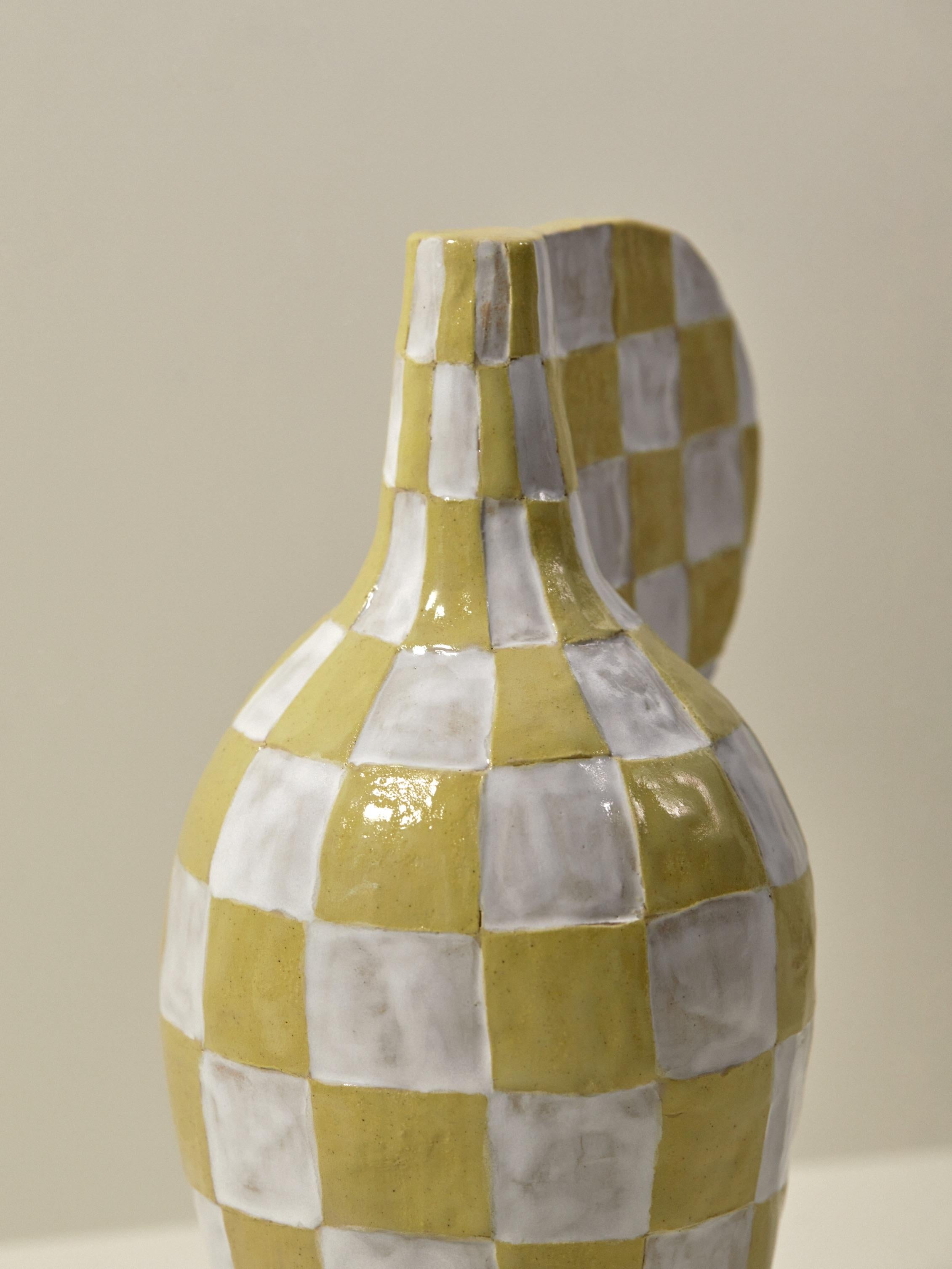 This piece is a playful handmade ceramic sculptural vase created by the Danish artist Maria Lenskjold for the series ‘Potion Bottles’. Like many of her works, upon closer inspection the piece is merely an abstraction —even a caricature of a vase—as