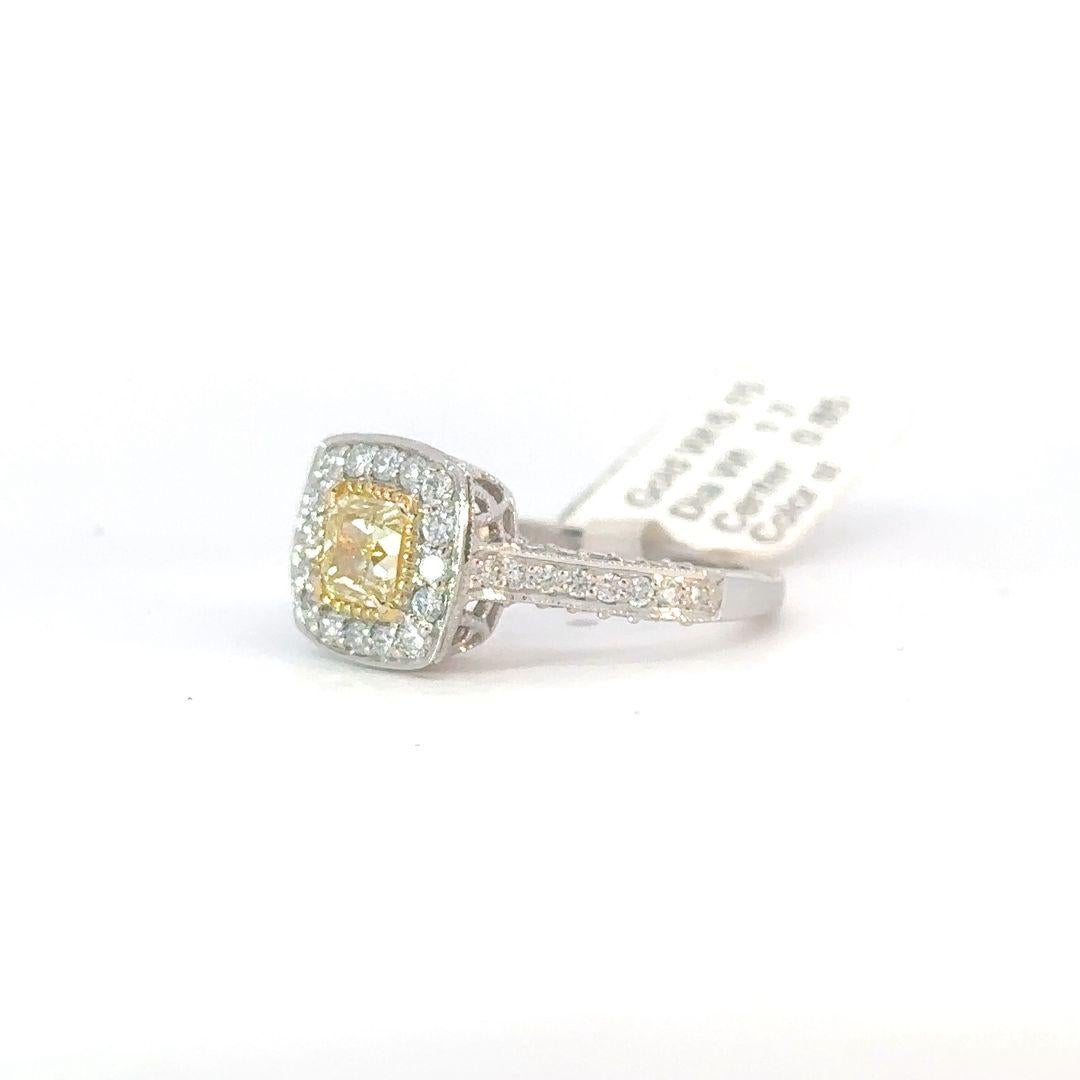 Step into the epitome of opulence with our exquisite yellow diamond ring, embraced by a stunning halo of radiant white diamonds. 
Nestled at the core of this captivating piece is a mesmerizing yellow stone, weighing 0.85 carats, exuding a warm and