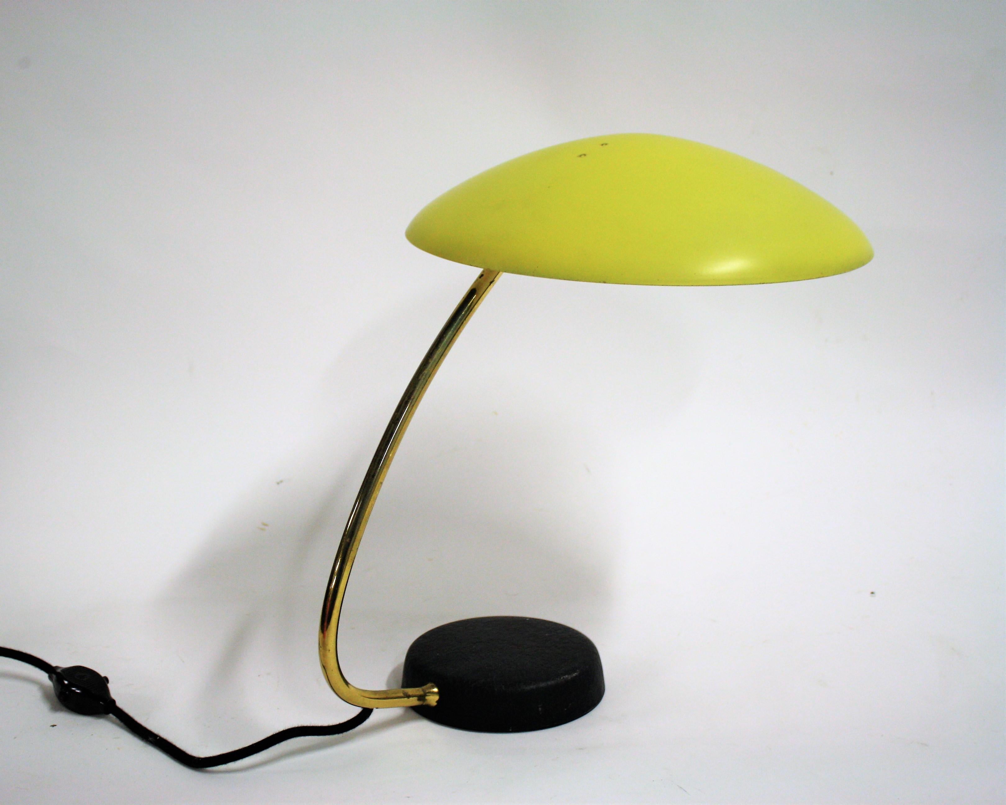 Vintage desk lamp by Cosasck Leuchten with a yellow shade and a black cast iron base.

Light patinated brass and bakelite switch to keep the original appeal.

The shade's angle can be adjusted in many ways, making it very useful.

Beautiful