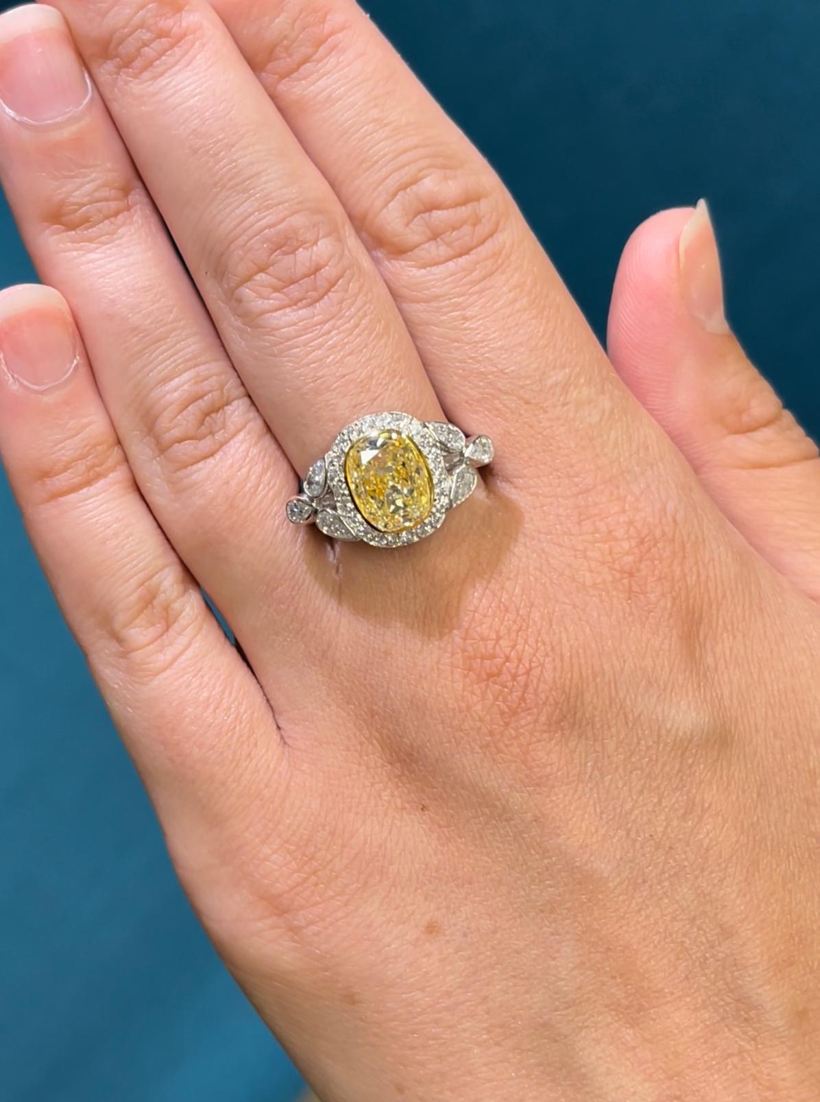 Light Yellow Diamond ring with EGL USA certificate, no.400148811D. Center stone: 3.03ct Cushion Modified Brilliant cut Light Yellow VS1 diamond, 9.90 x 7.40 x 5.16 mm. Side stones: 6 Pear shape diamonds and 38 Brilliant Round cut diamonds: 1.35ct