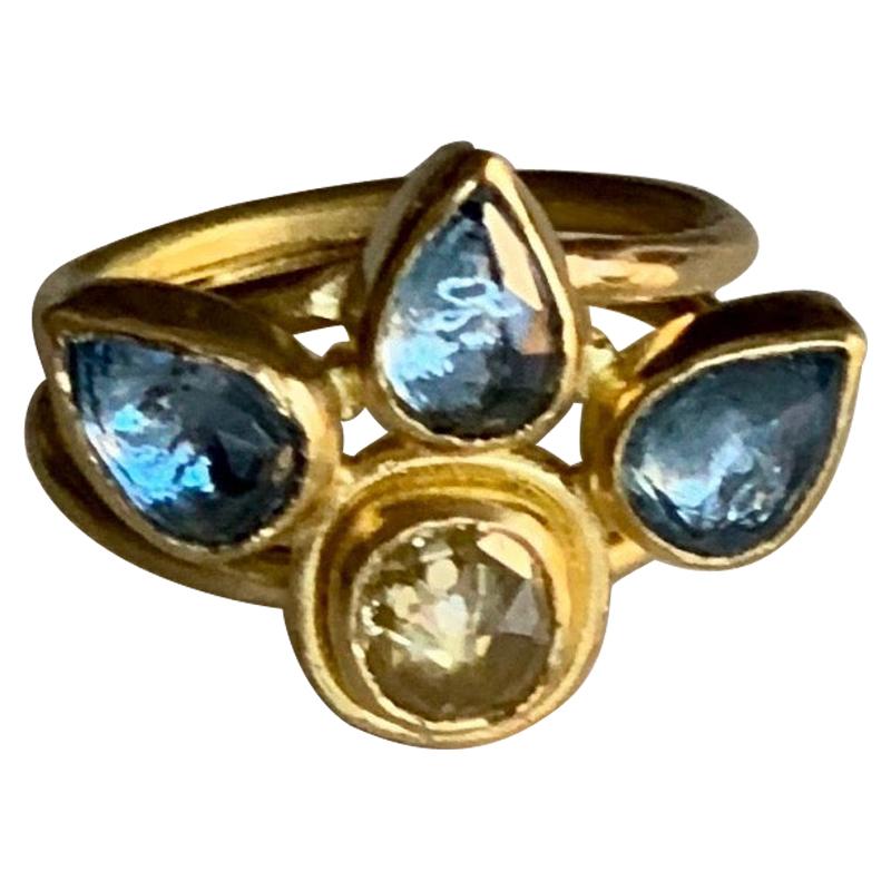 Lotus flower inspired ring with a natural yellow rose cut Diamond weighing .55 carats and rose cut pear shaped Aquamarines weighing 2 carats.
Aquamarine is the birthstone for the month of March.
The stones are set in 22Karat gold and the band is 20