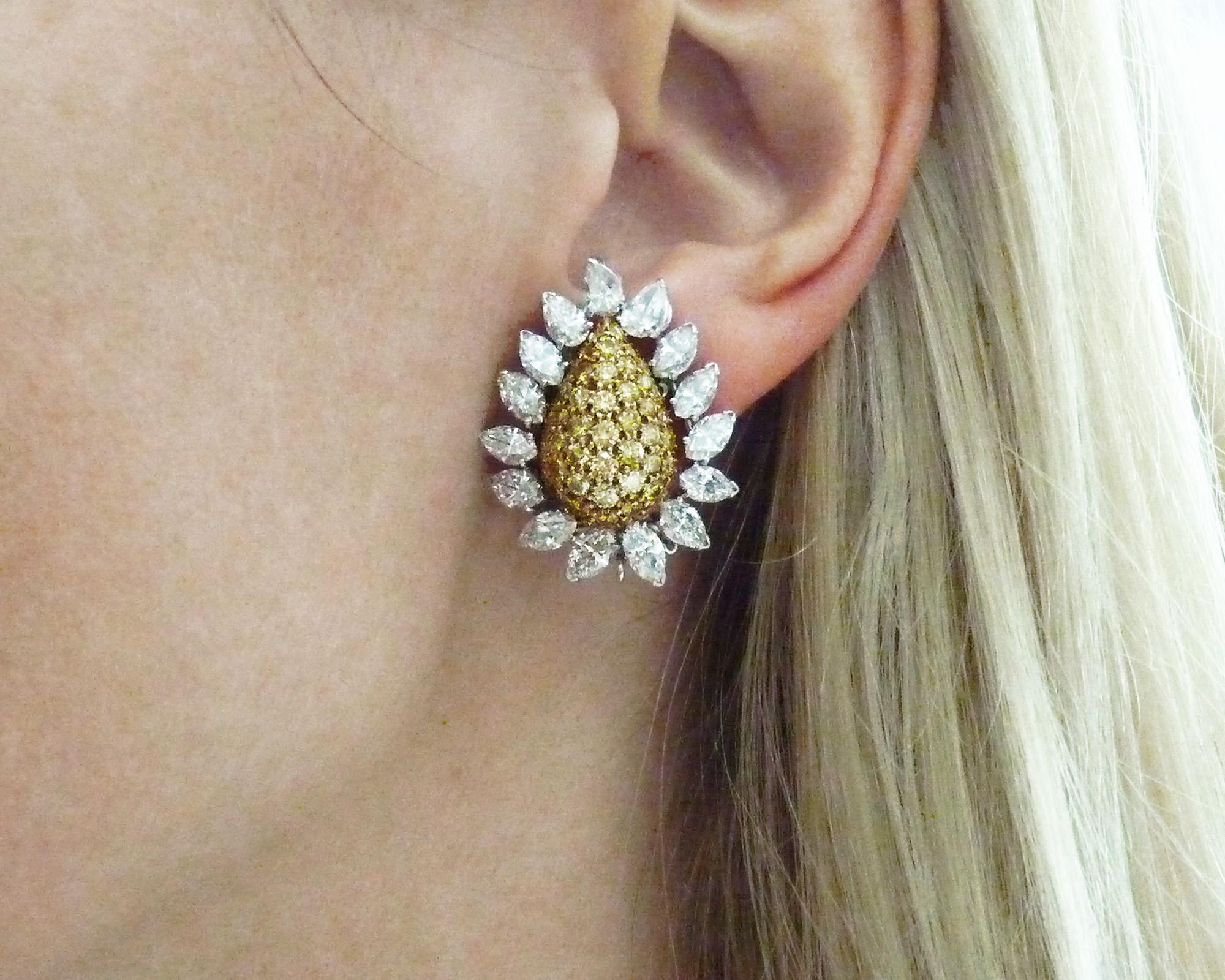 This pair of signed Van Cleef & Arpels Yellow and White Diamond Flower Earrings, made in France in the Contemporary era, 21st century, are crafted in platinum and 18K yellow gold, and feature pave-set yellow diamonds with an estimated weight of 6.00