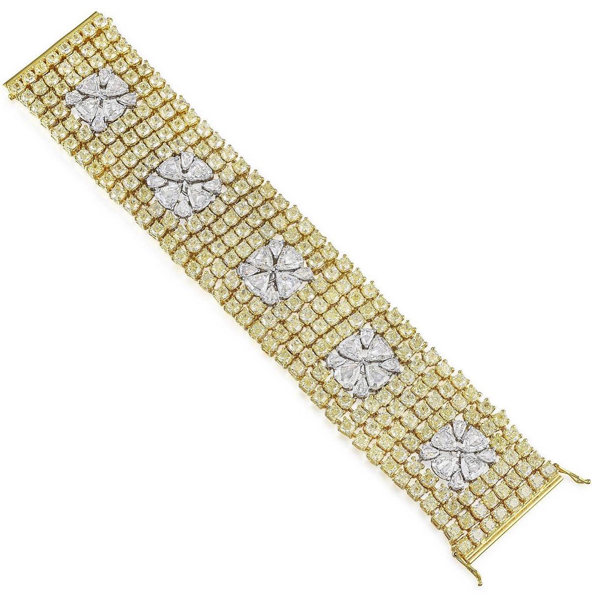 This gorgeous yellow and white diamond wide and flexible bracelet is beautifully hand made in 18 karat yellow gold. 

The details are as follows; 

Yellow diamond weight : 47.44 carats with VVS clarity 
( 236 pieces ) 
White diamond weight : 16.46