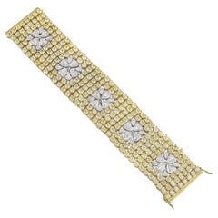 Breites Armband aus 18 Karat Gelbgold mit gelben Diamanten und weißen Diamanten. 