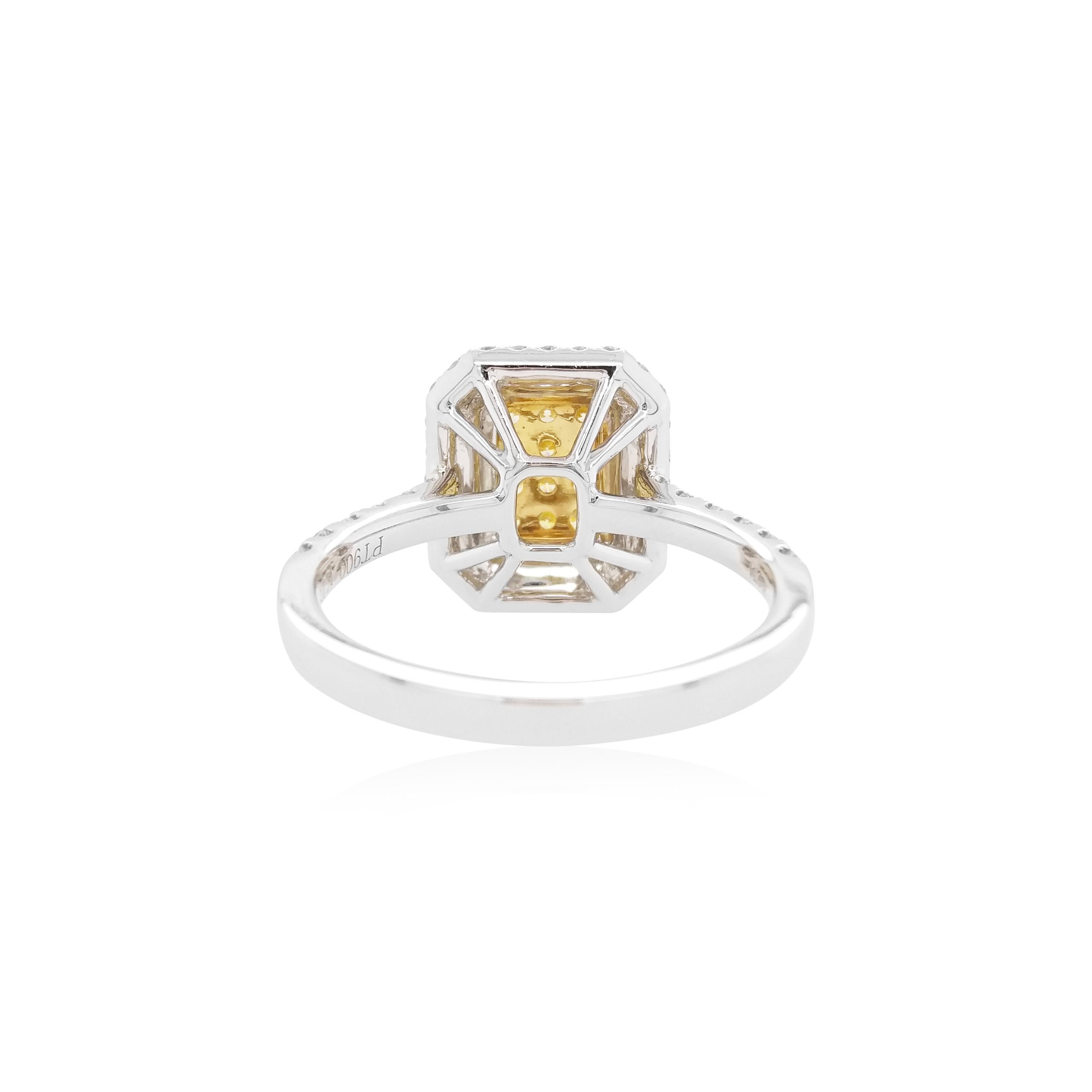 This elegant ring features lustrous natural Yellow diamonds at the centre of the design, surrounded by halos of scintillating white diamonds. The rich colour of these diamonds is complimented perfectly by the delicate platinum and 18 Karat Yellow