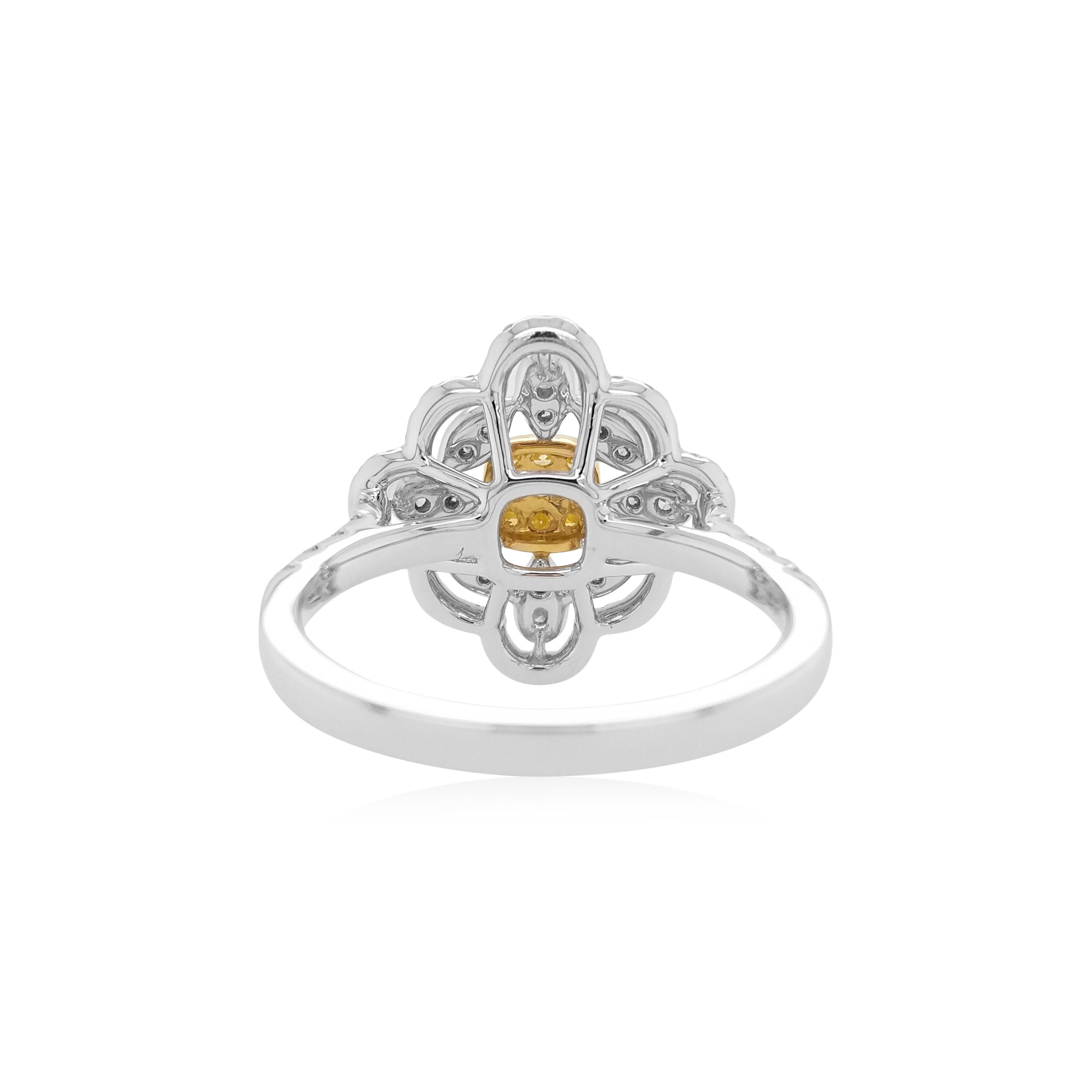 This exclusive cocktail ring features luscious natural Yellow diamonds at the heart of the design, by framing an ornate arrangement of delicate white diamonds set in platinum. Bold and striking, this unique ring is the perfect statement piece -