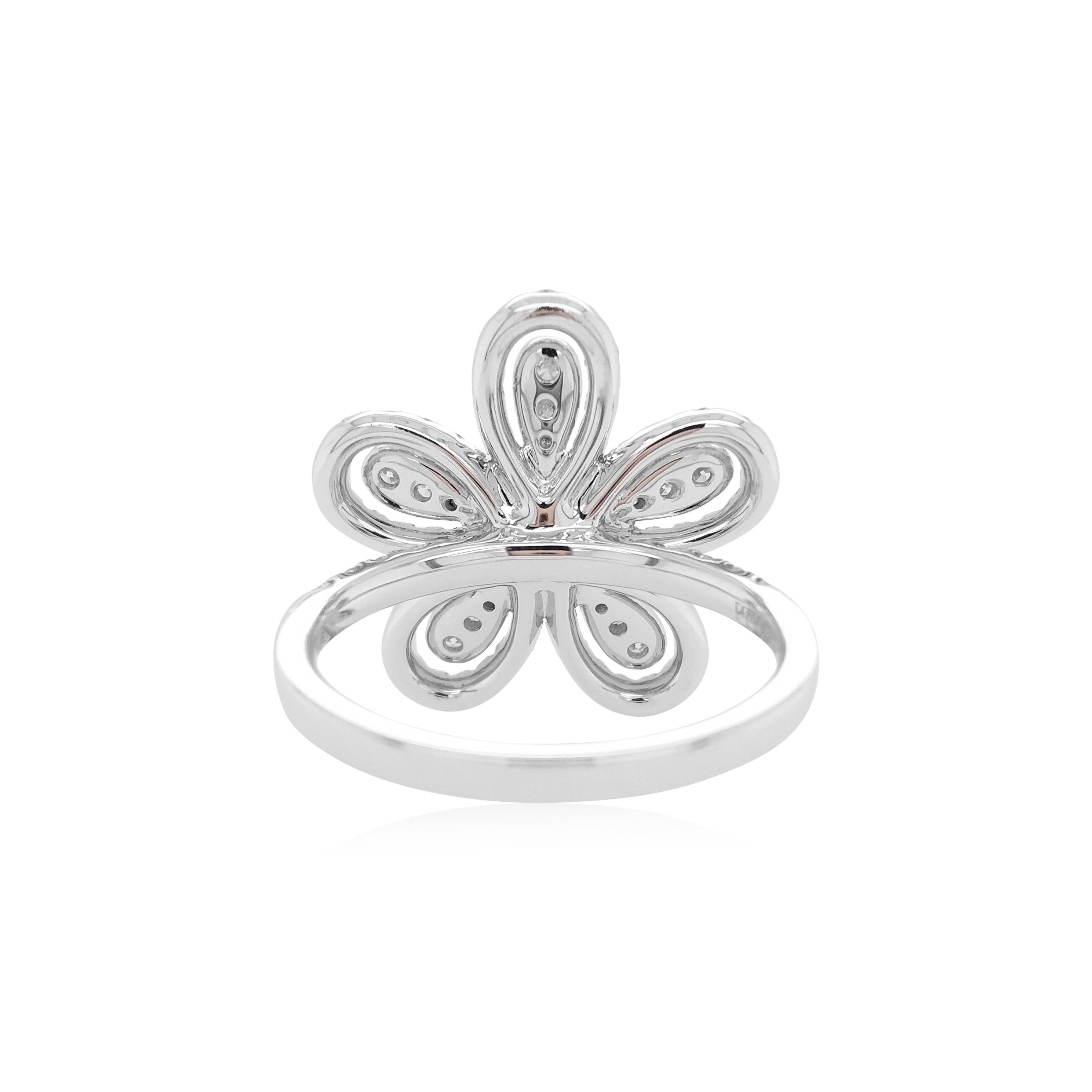 This unique flower shaped ring features striking Yellow diamonds at the heart of the design. The rich colour of these diamonds is complimented perfectly by the delicate platinum floral design which completed by a combination of glistening white