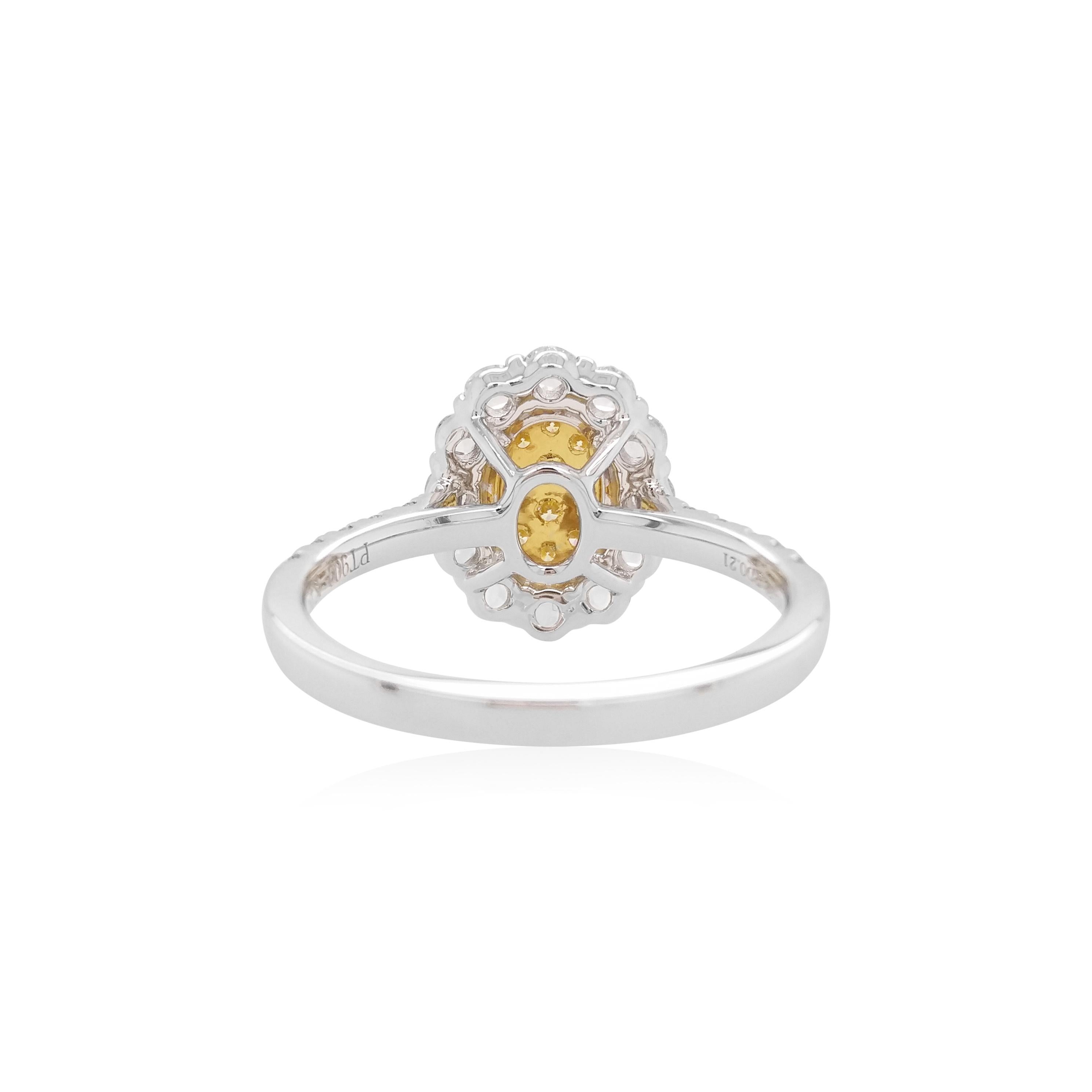 This mesmeric platinum ring features natural Yellow diamonds at its forefront, accentuated by a halo of glistening Rose-cut white diamonds which surrounds it. Bold, yet intricate, this one-of-a-kind ring will add a sumptuous touch of colour to your