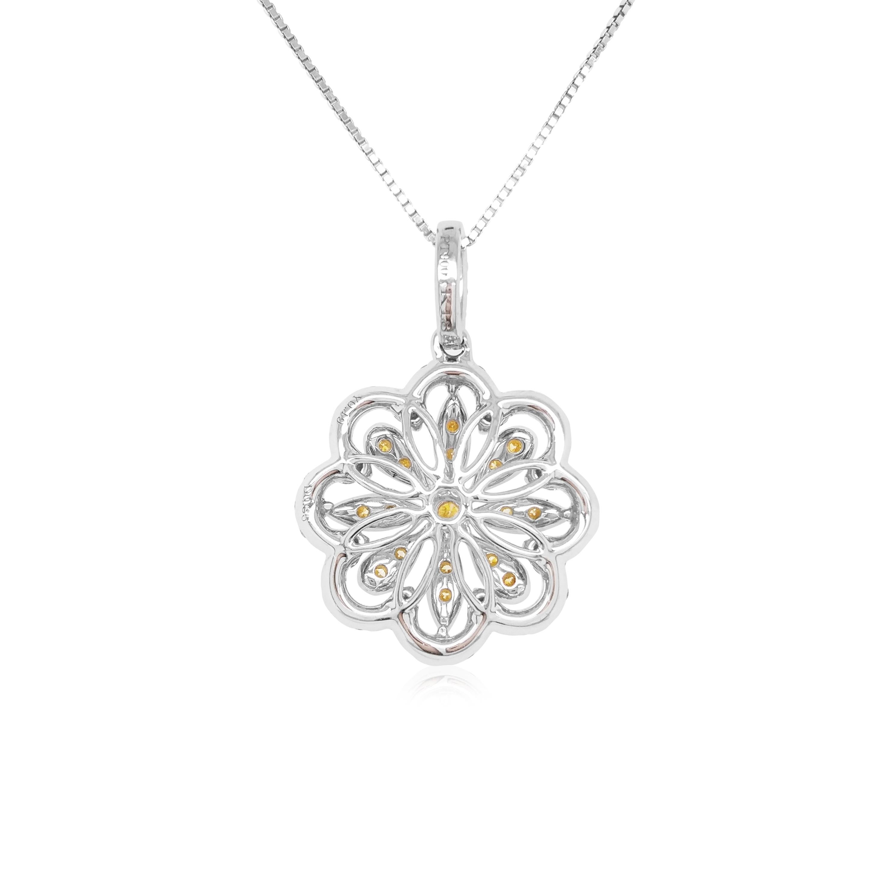 This unique flower shaped pendant features natural Yellow diamonds at the heart of the design. The rich colour of these diamonds is complimented perfectly by the delicate platinum floral design which completed by a combination of round brilliant-cut