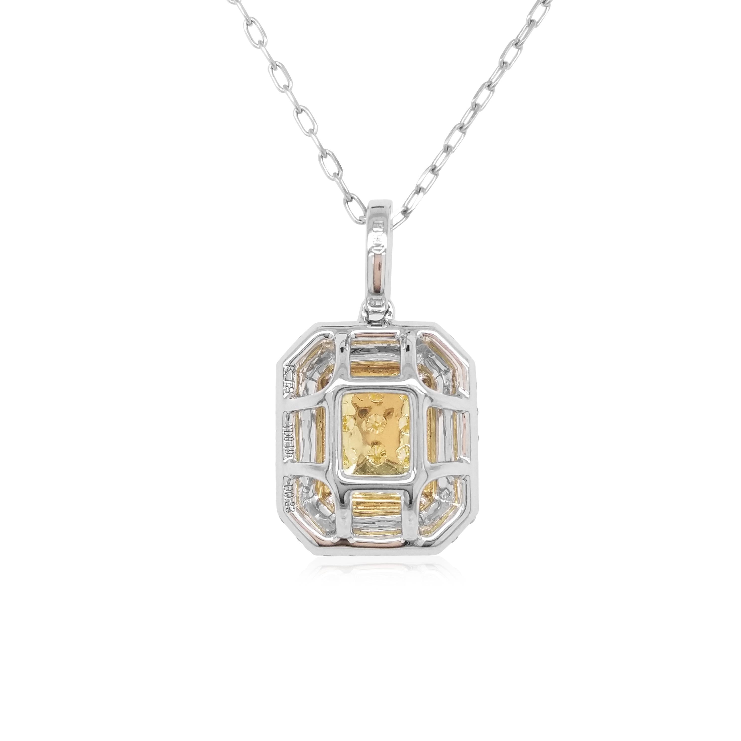 This elegant pendant features lustrous natural Yellow diamonds at the centre of the design, surrounded by halos of scintillating white diamonds. The rich colour of these diamonds is complimented perfectly by the delicate platinum and 18 Karat Yellow